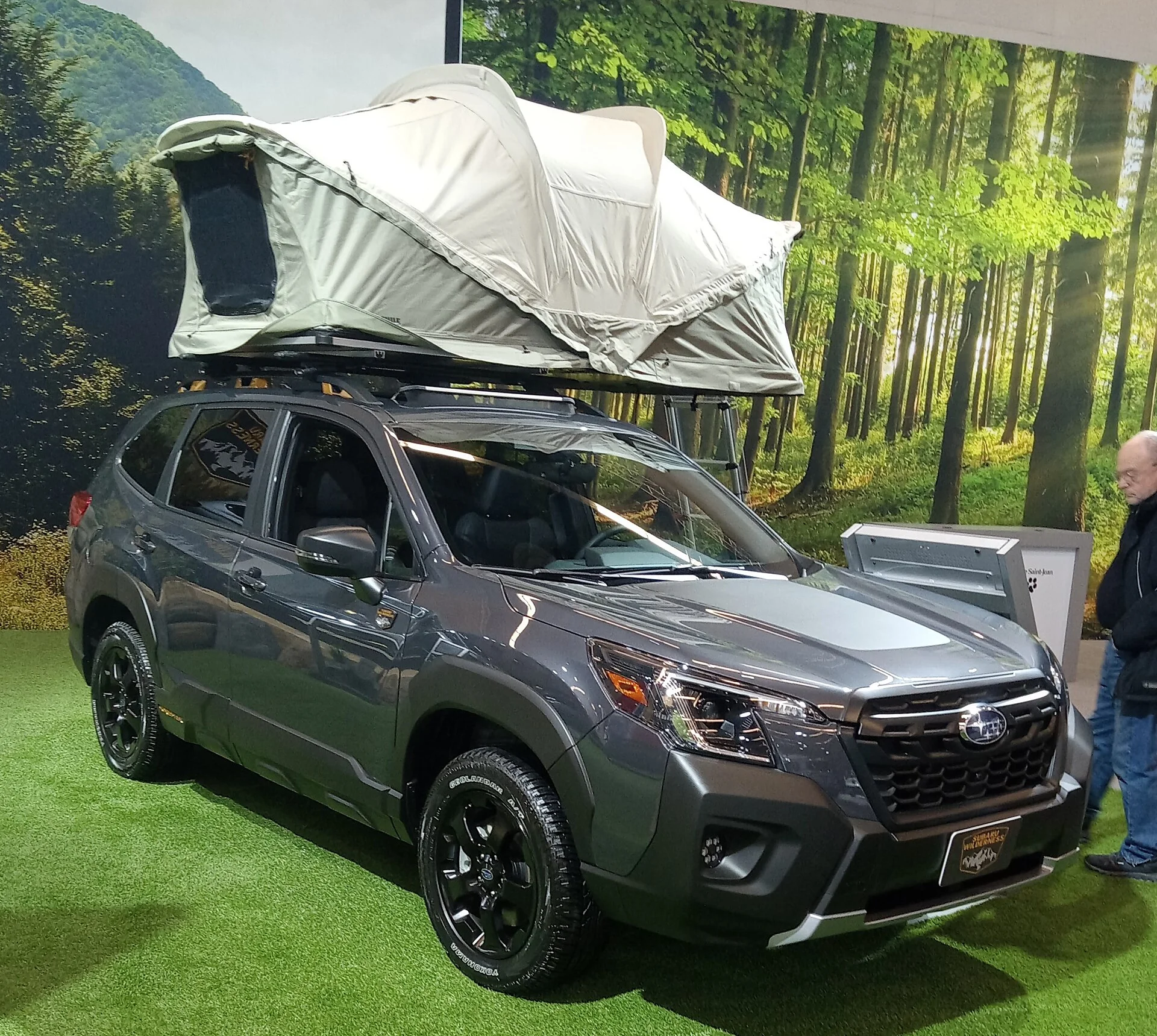 Grey Subaru Forester Wilderness with a rooftop tent mounted and open on the roof