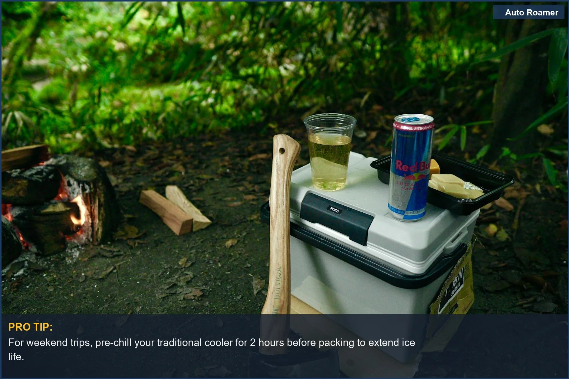 Serene campsite with axe, fire, and cooler highlights the viability of traditional coolers for camping.