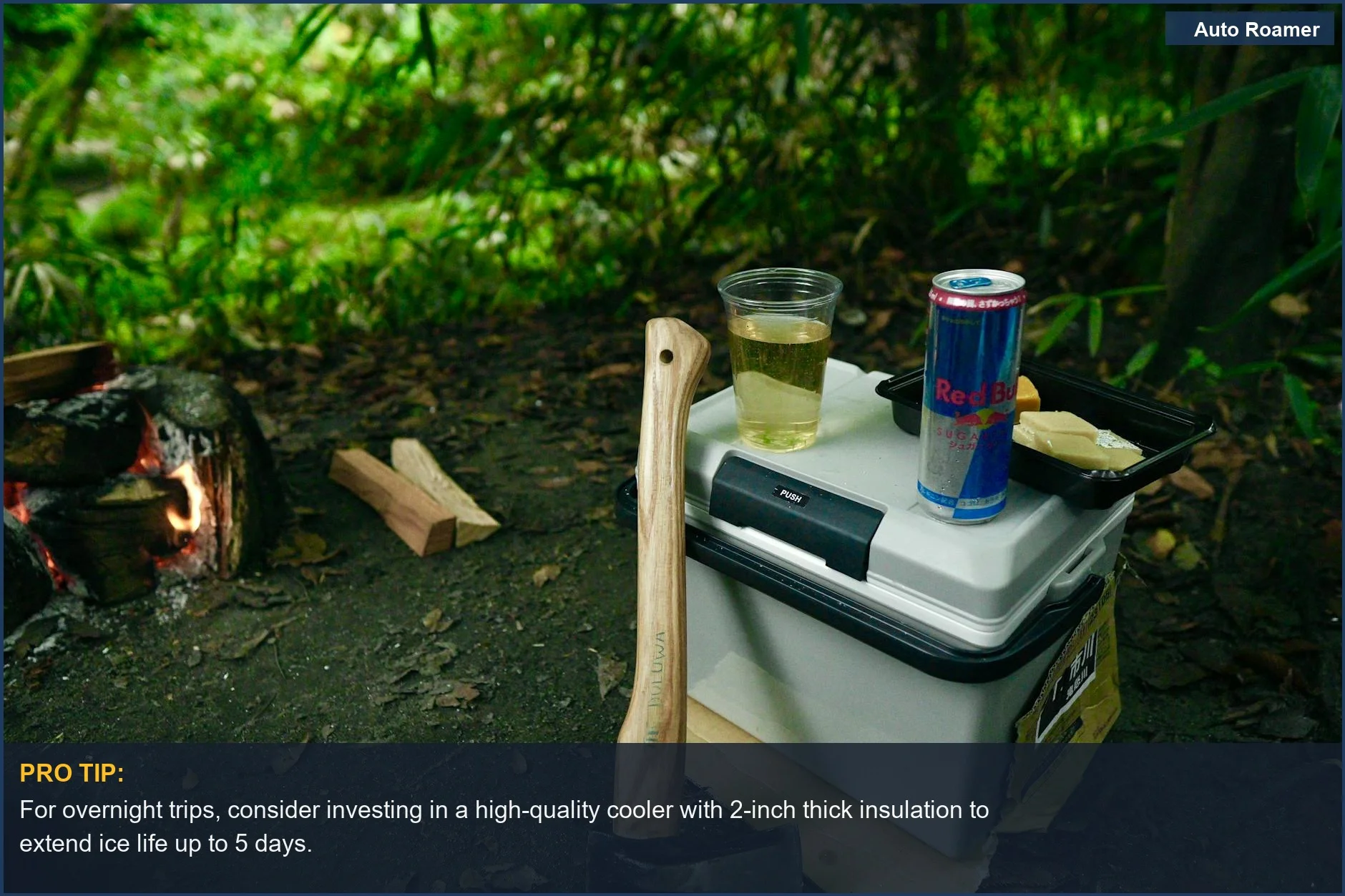Serene campsite scene with a cooler, axe, and energy drink, showcasing essential gear for outdoor adventures.
