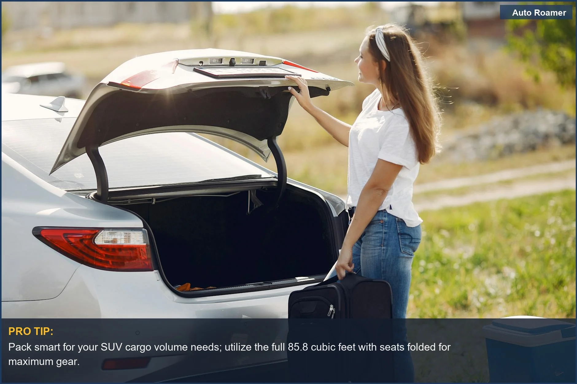 Cheery female traveler efficiently loads luggage into the spacious trunk of a modern SUV for a countryside excursion.