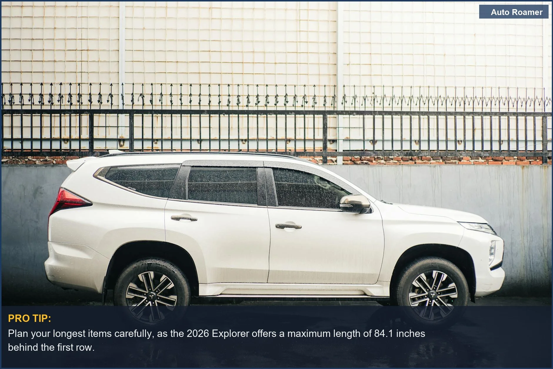 Side profile of a modern white 2026 Ford Explorer in an urban setting, emphasizing its sleek design and cargo dimensions.