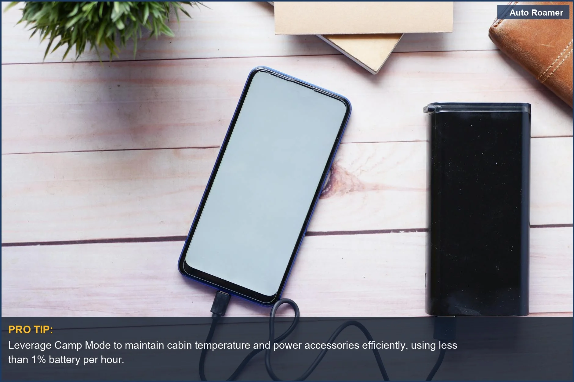 Person charging a smartphone with a power bank, an essential Tesla Model Y accessory for car camping power.