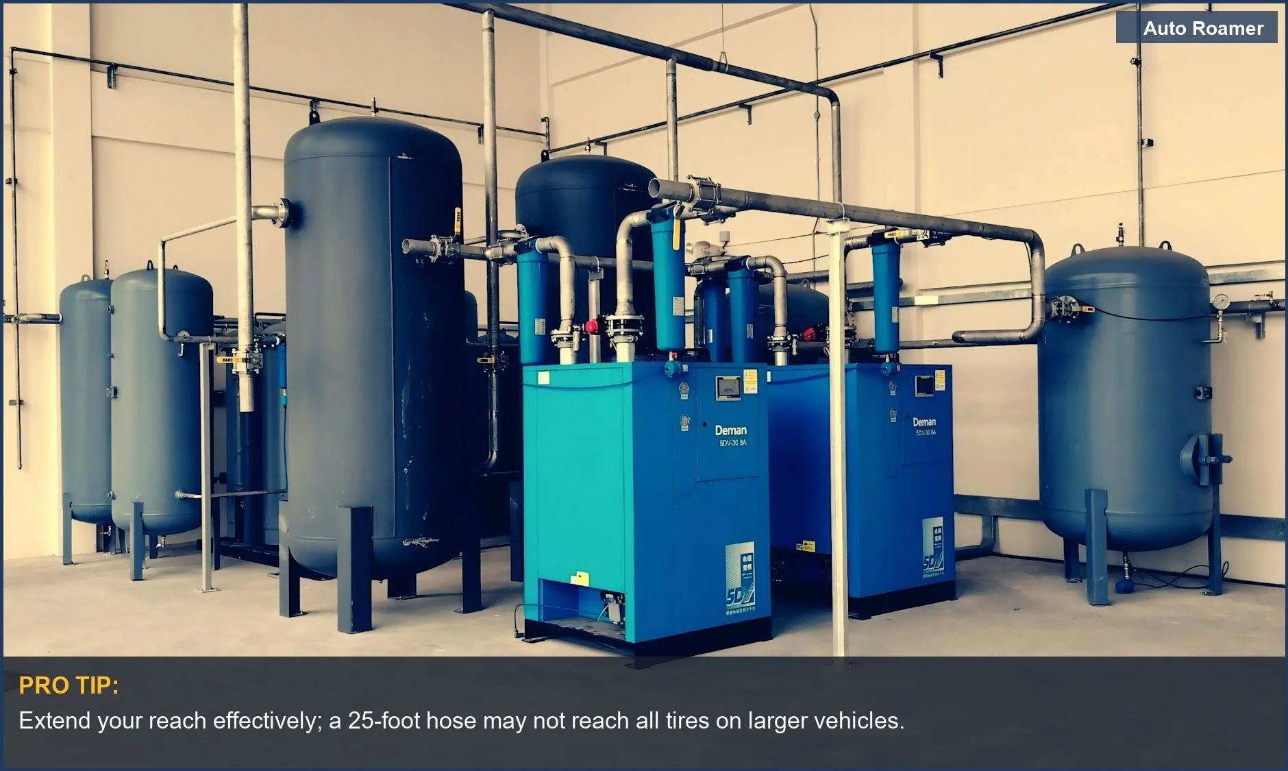 Industrial air compressor setup with blue tanks and pipes, demonstrating the need for adequate hose length.
