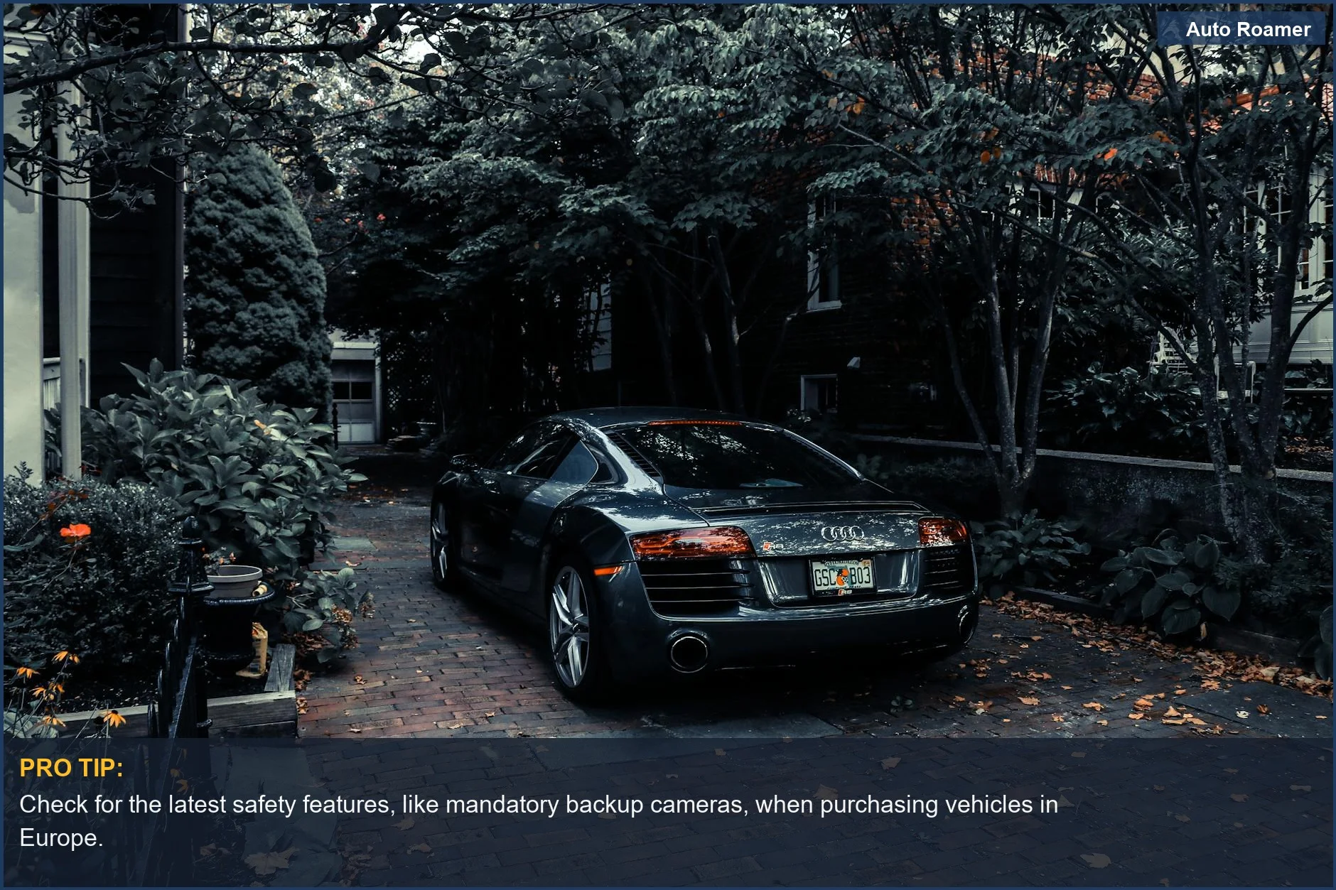 Sleek Audi R8 in a driveway, demonstrating advanced vehicle safety technology.