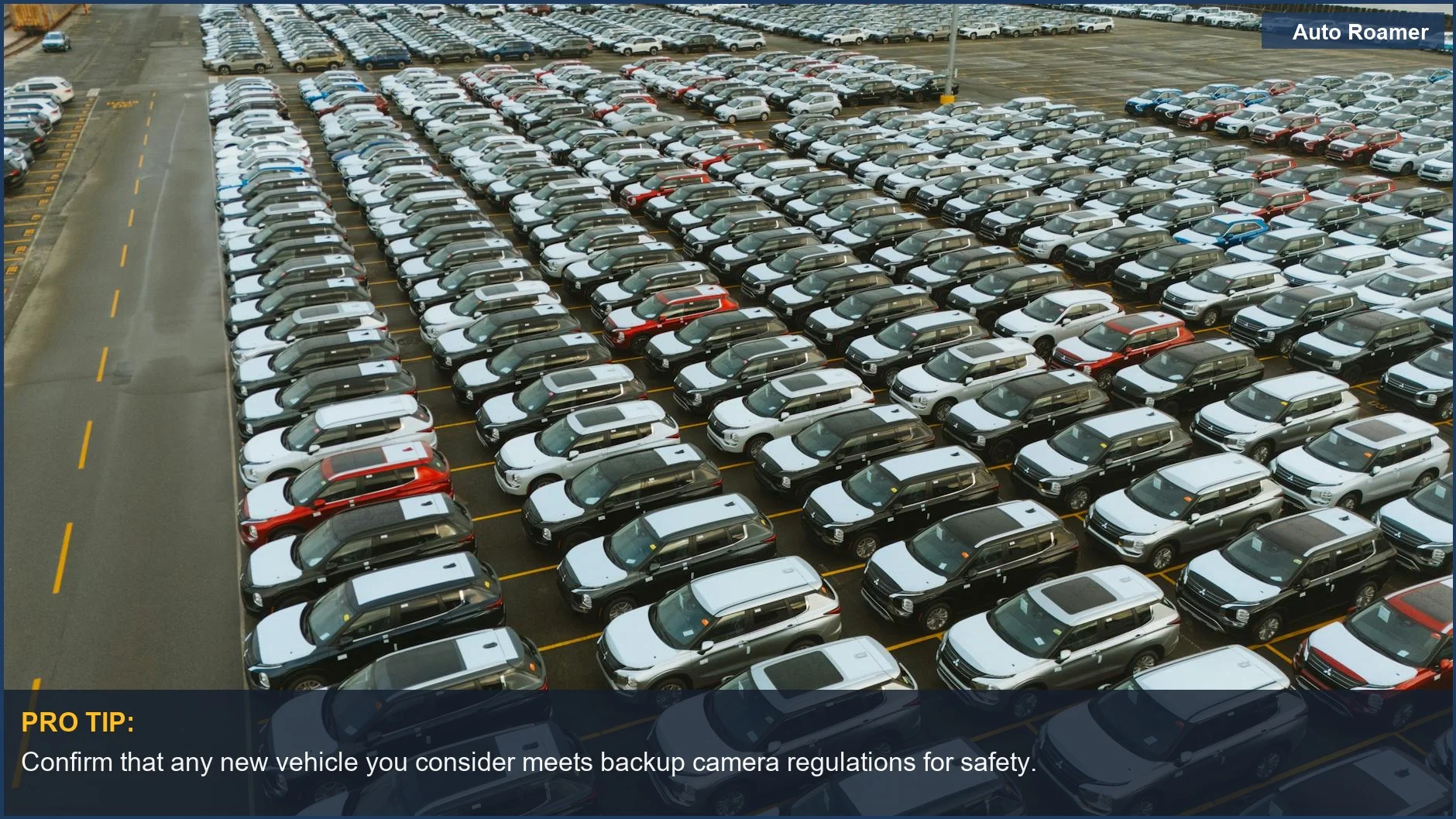 Aerial view of a large parking lot filled with new cars ready for sale.