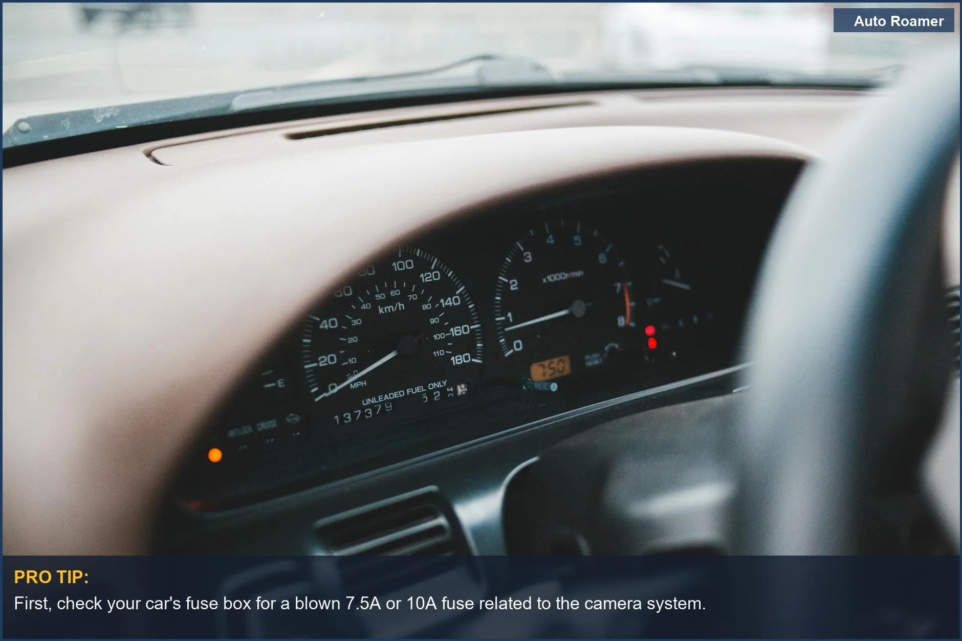 Modern car dashboard with illuminated indicators on a wide display, troubleshooting a backup camera black screen.