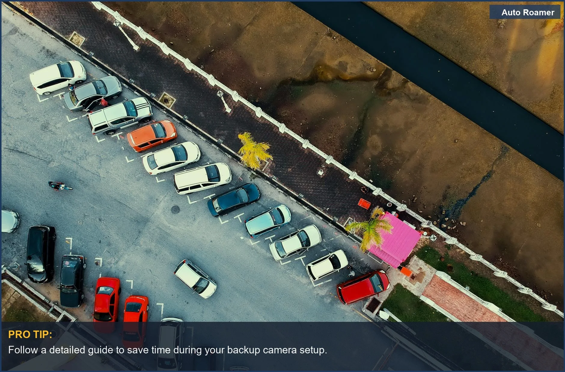 Aerial view of a parking lot with various cars, emphasizing the need for backup camera installation.