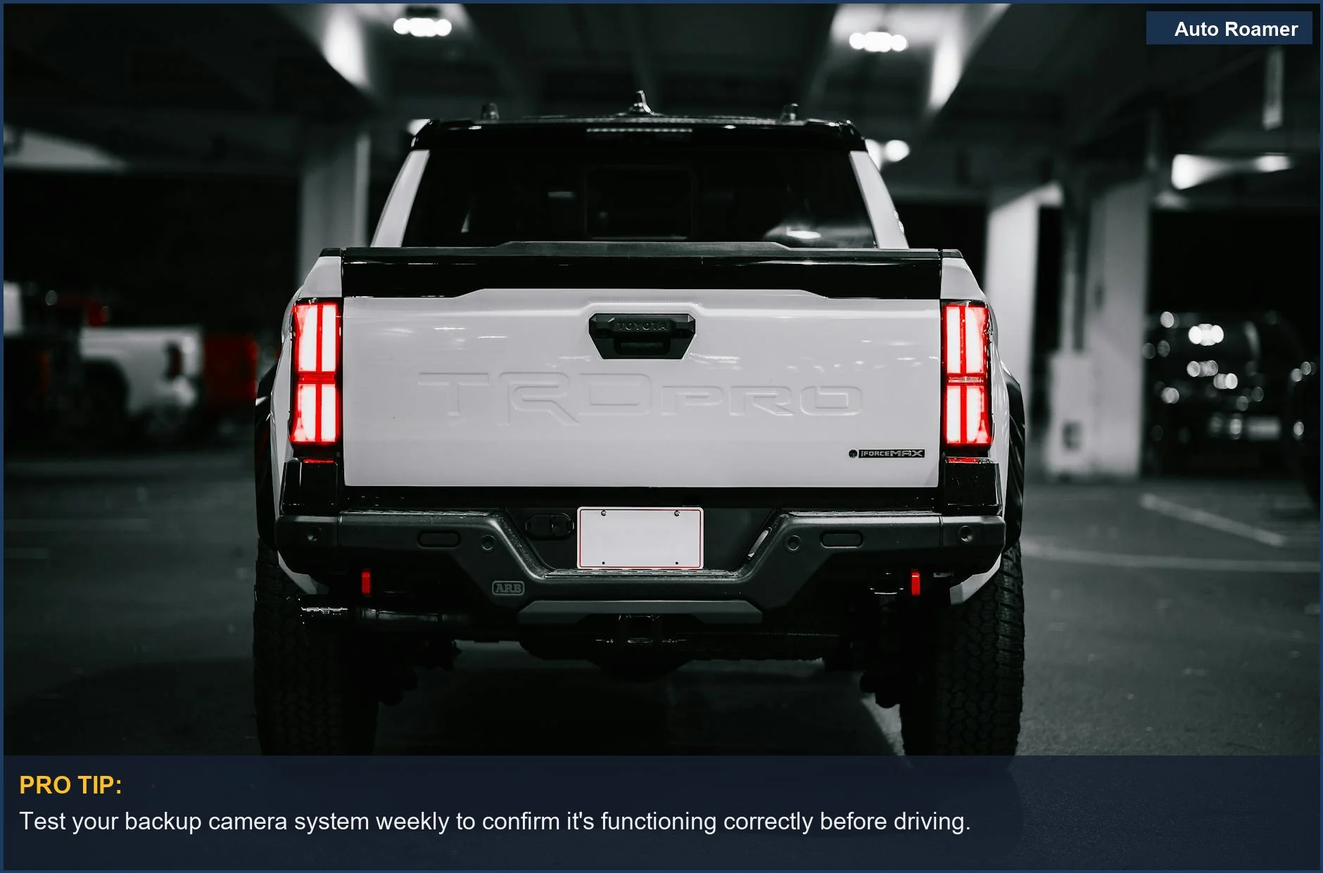 White pickup truck tail lights illuminated in a parking garage, a common sight under backup camera law Canada.