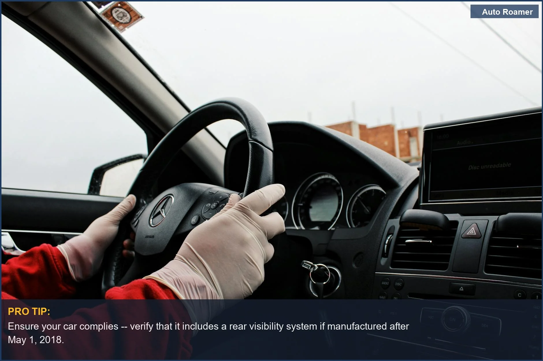 Driver wearing gloves in a Mercedes-Benz, emphasizing safety and hygiene while driving.