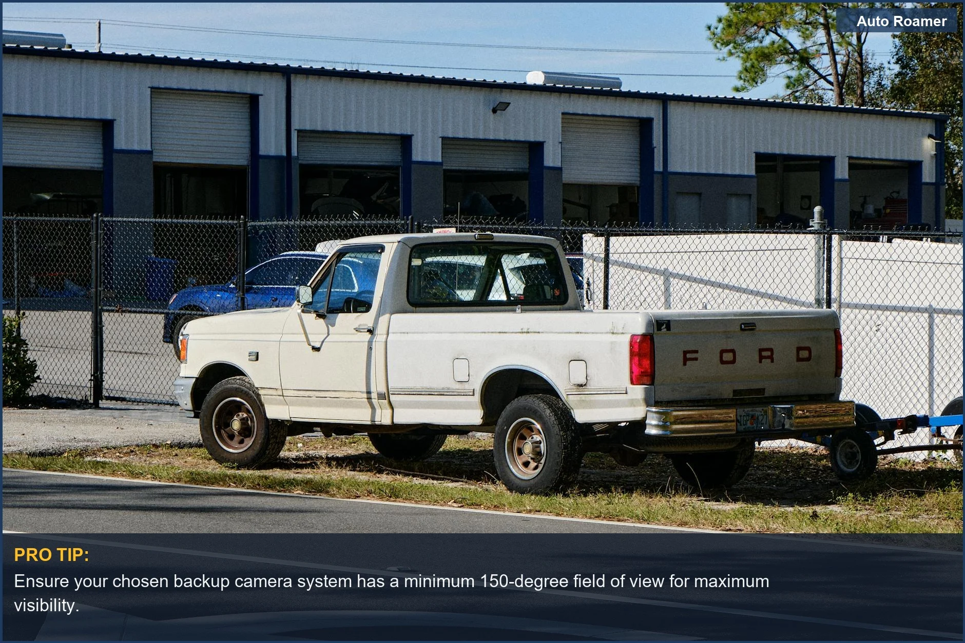Classic white pickup truck parked by a garage, great for older vehicle tech upgrades.