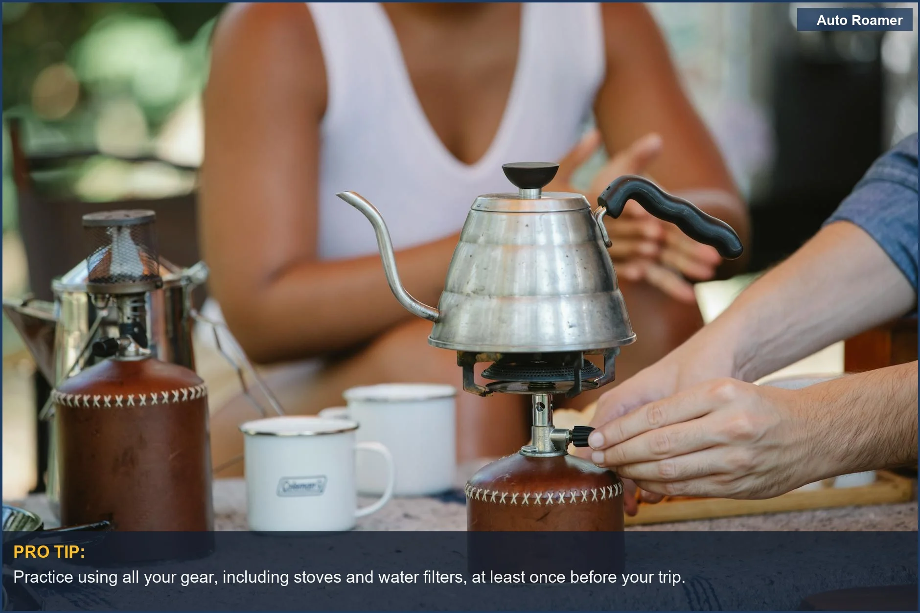 Couple brewing coffee on a portable camping stove, a key part of beginner camping mistakes to avoid.
