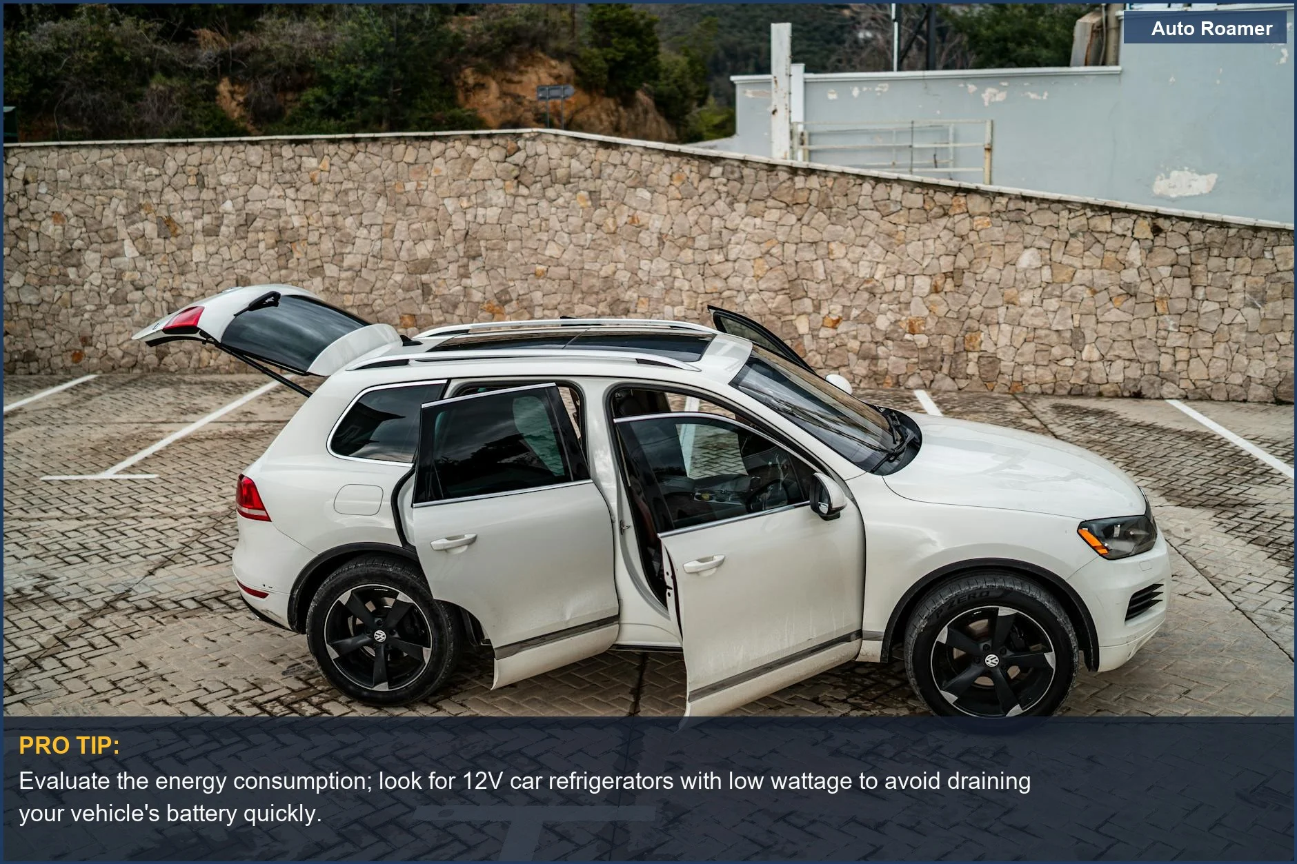Modern white SUV with open doors parked outdoors, ready for a road trip with a 12V refrigerator.