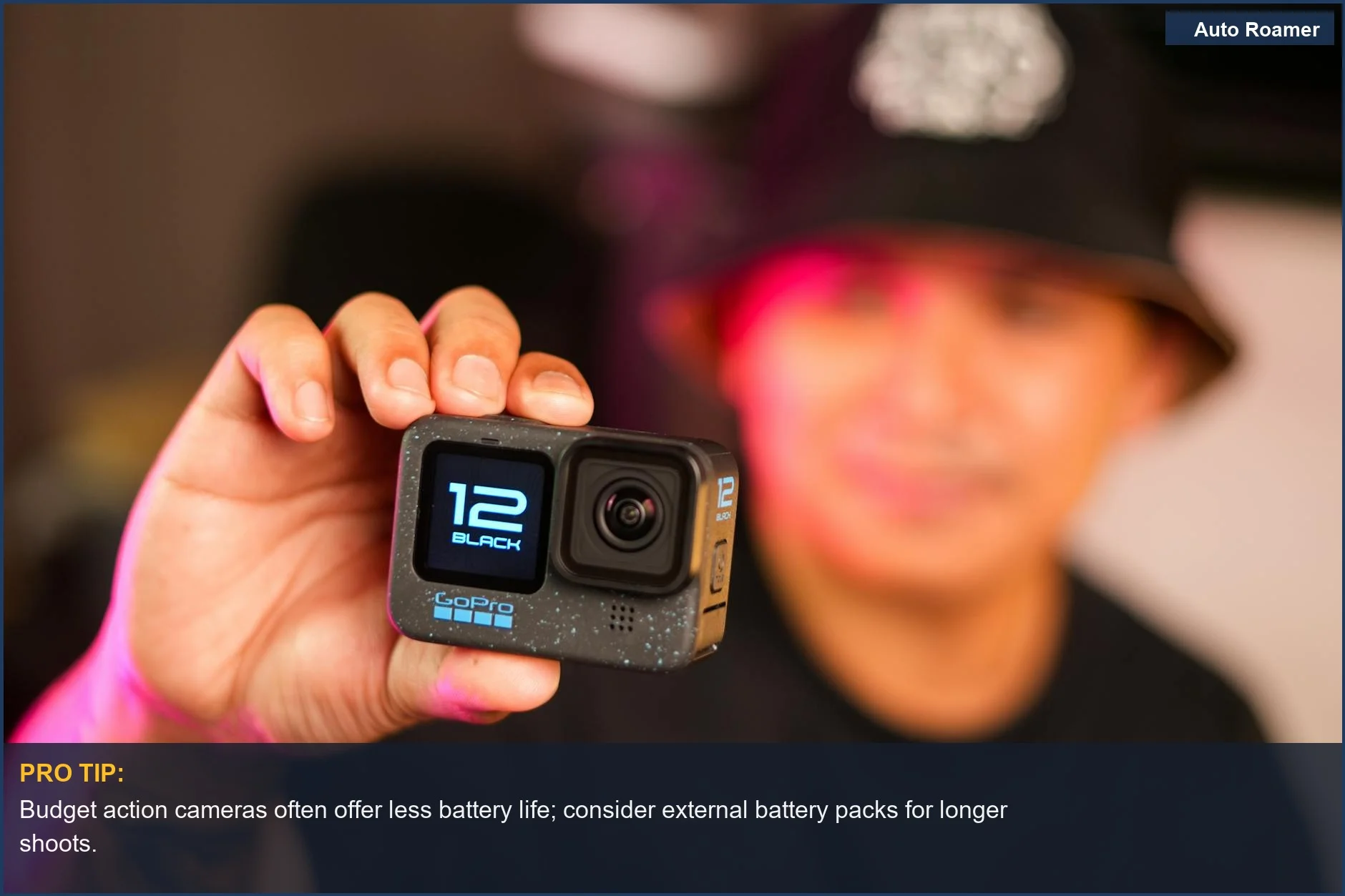 Close-up of a man's hand holding a sleek action camera, showcasing its compact design.