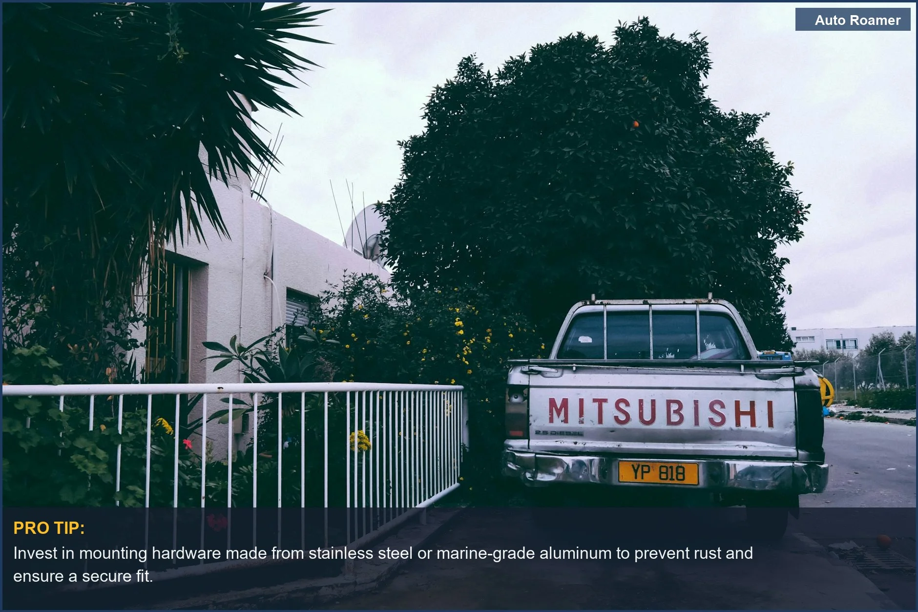 Affordable backup camera system for older trucks, shown on a Mitsubishi pickup in a bright Cypriot urban setting.