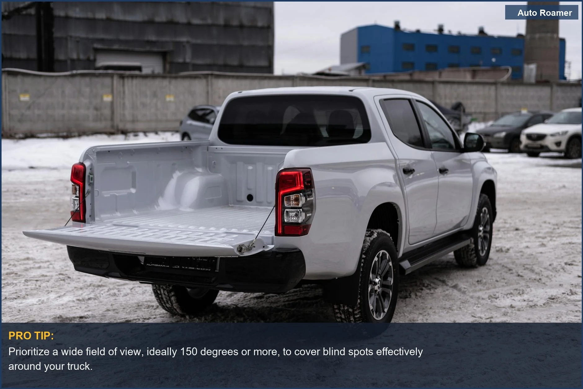 Best backup camera for older trucks, featuring a white pickup with an open bed in a snowy industrial zone.