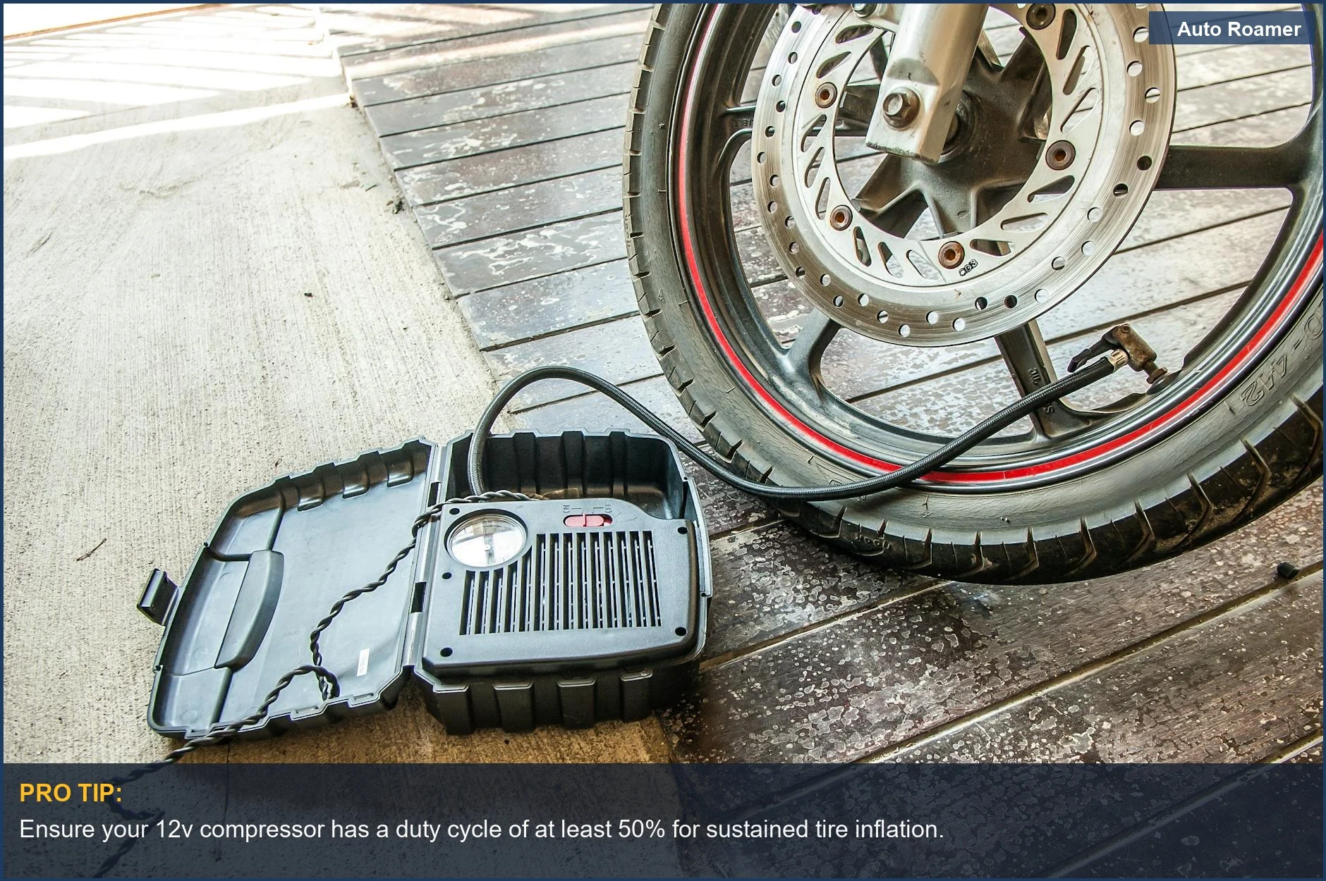 Portable 12v air compressor inflating a motorcycle tire for optimal camping readiness.