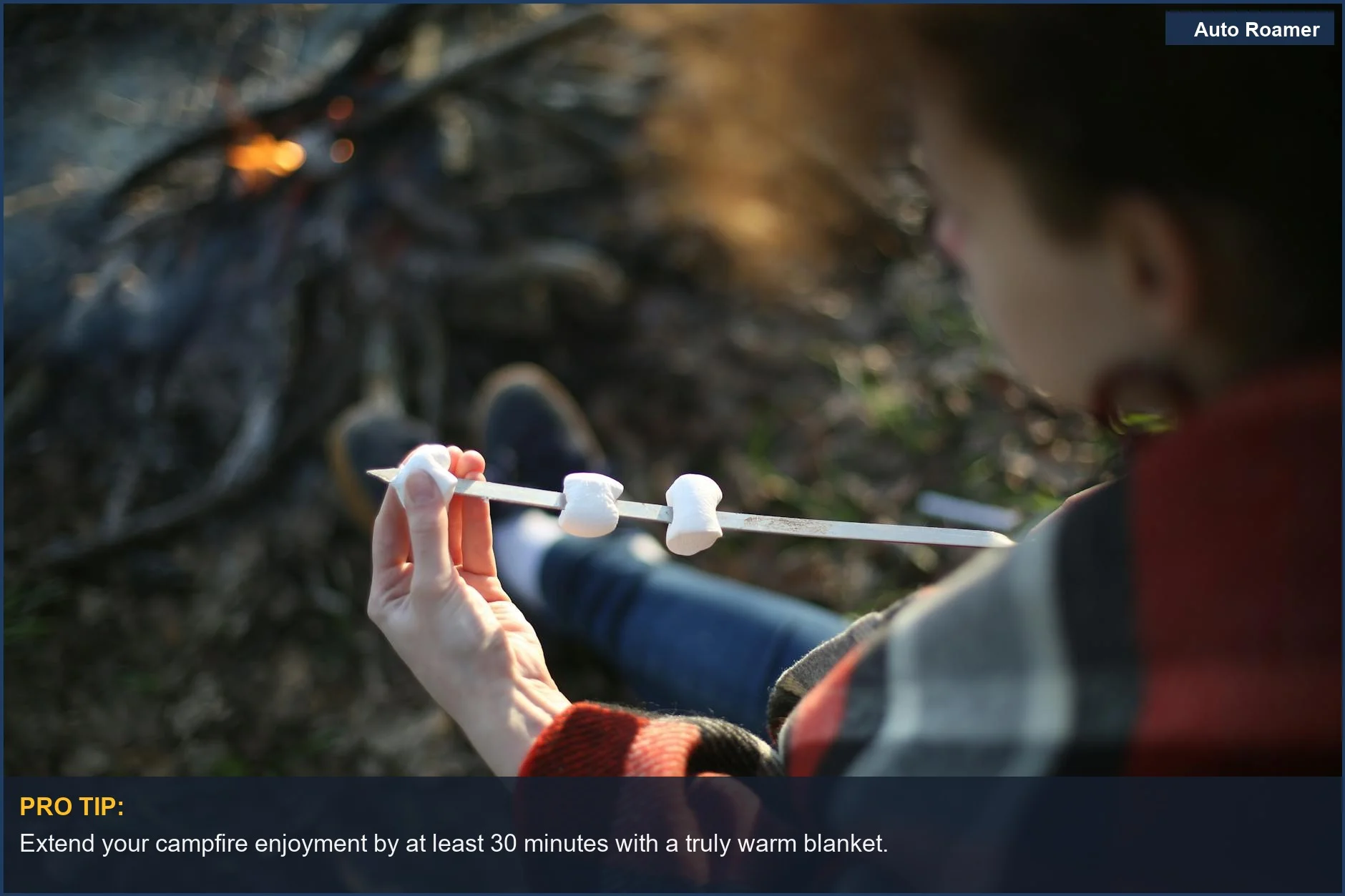 Person roasting marshmallows over a campfire, wrapped in a warm car camping blanket.