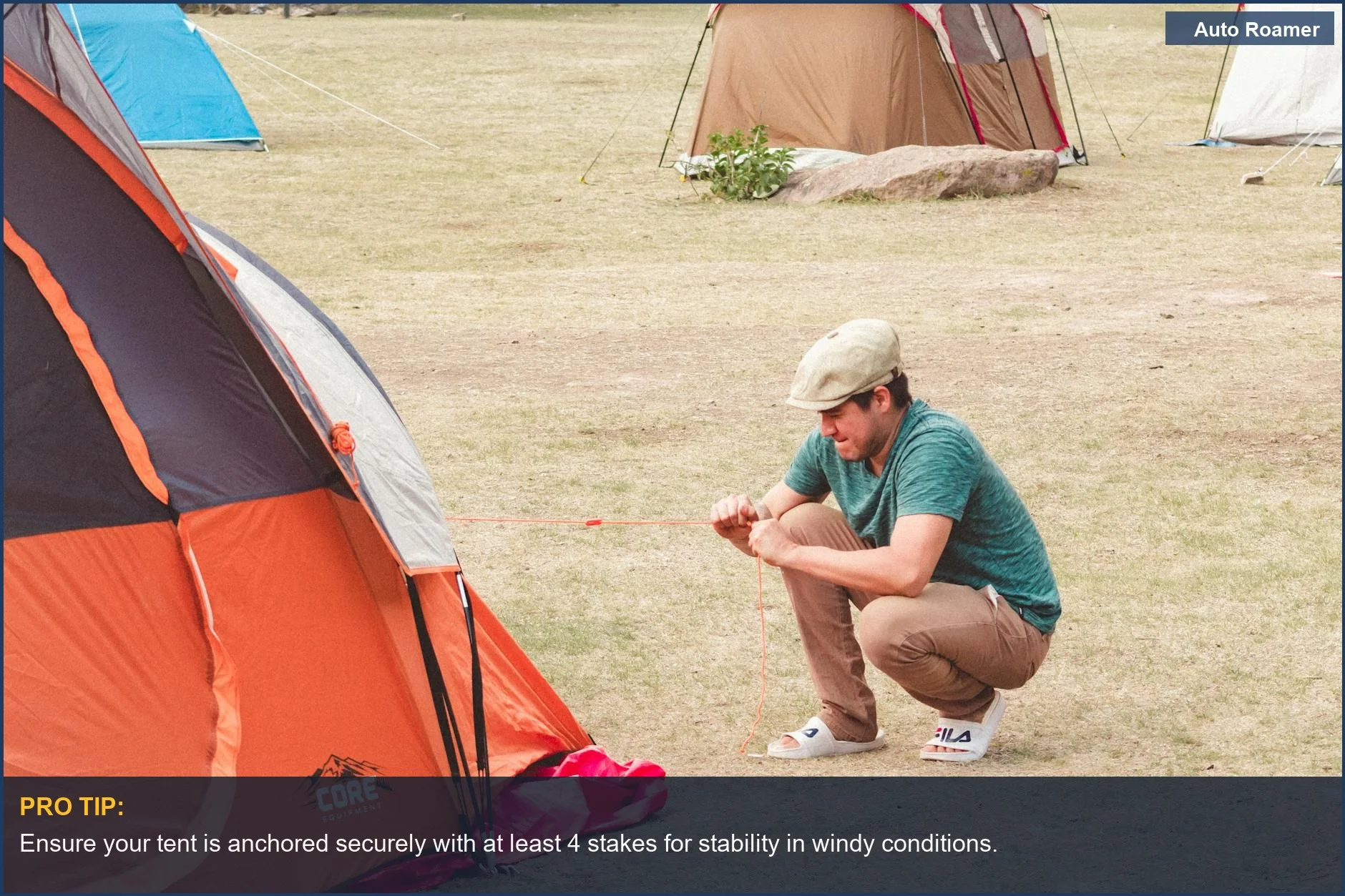 Man setting up orange tent for car camping with a plugged-in cooler nearby.