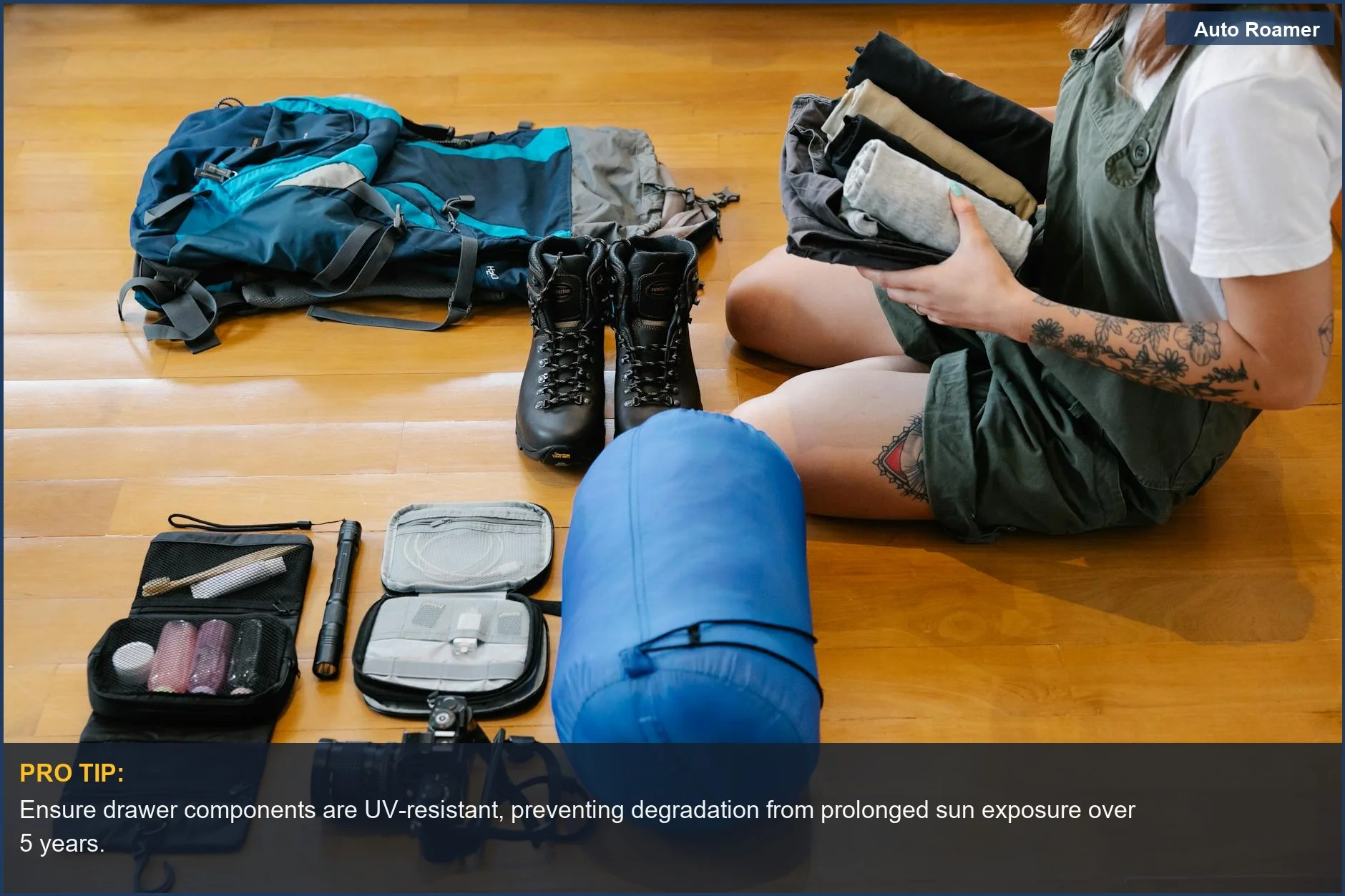 Woman organizing camping gear indoors, demonstrating the practical benefits of a truck bed drawer system for car camping.