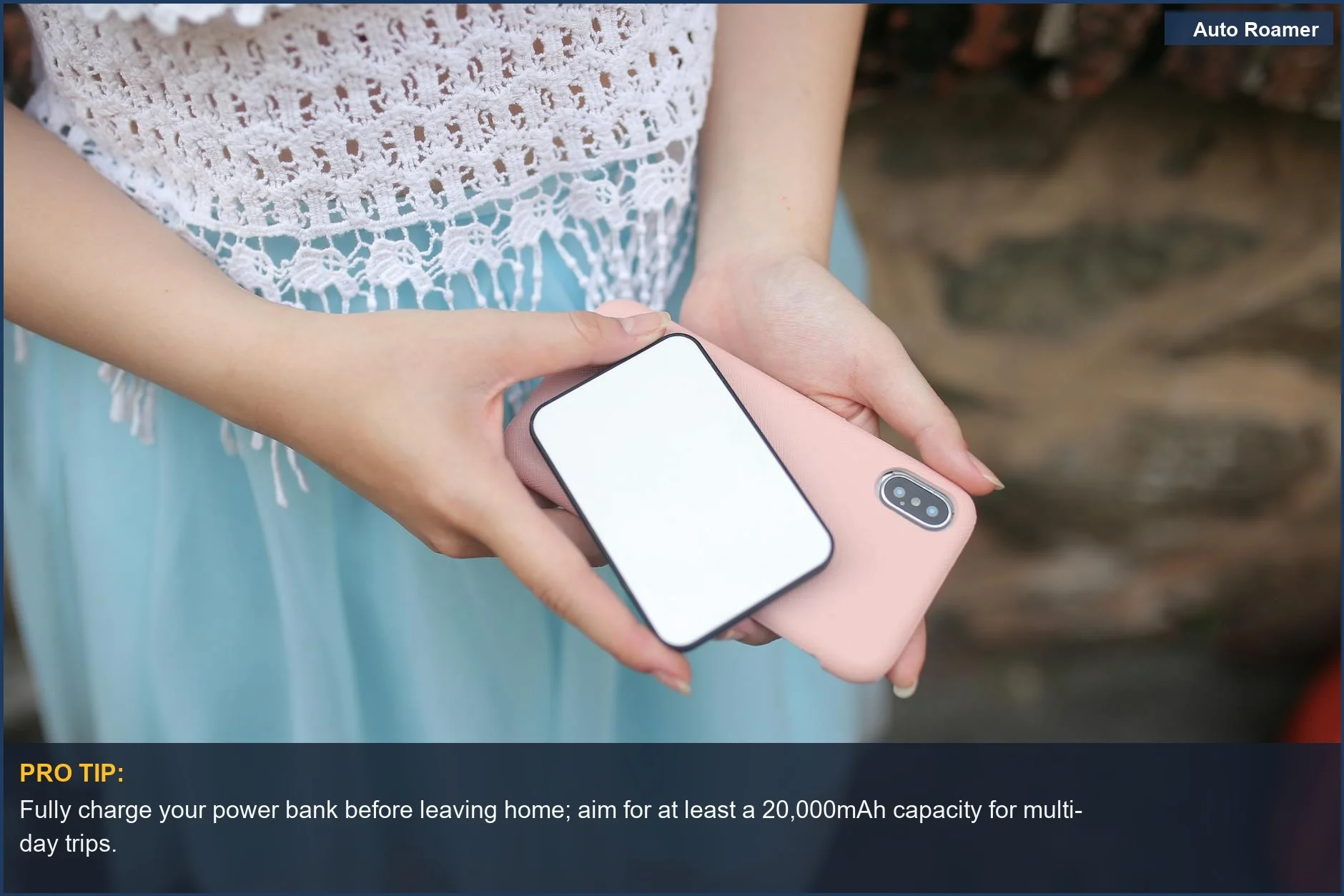 Woman uses power bank and smartphone for car camping tech essentials, ensuring connectivity on the go.