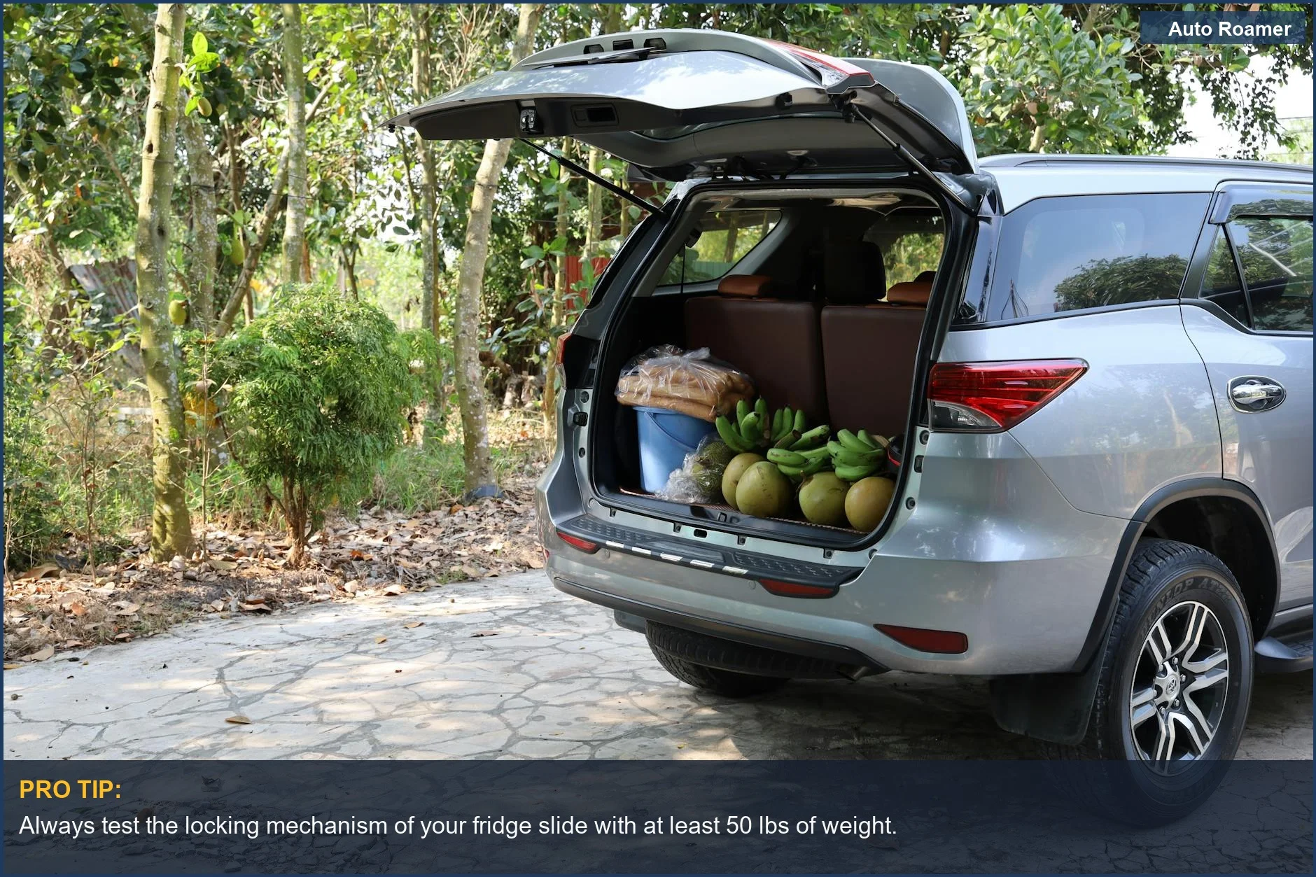 SUV's open trunk in Vietnam displays fresh tropical fruits and bread, highlighting food storage solutions.