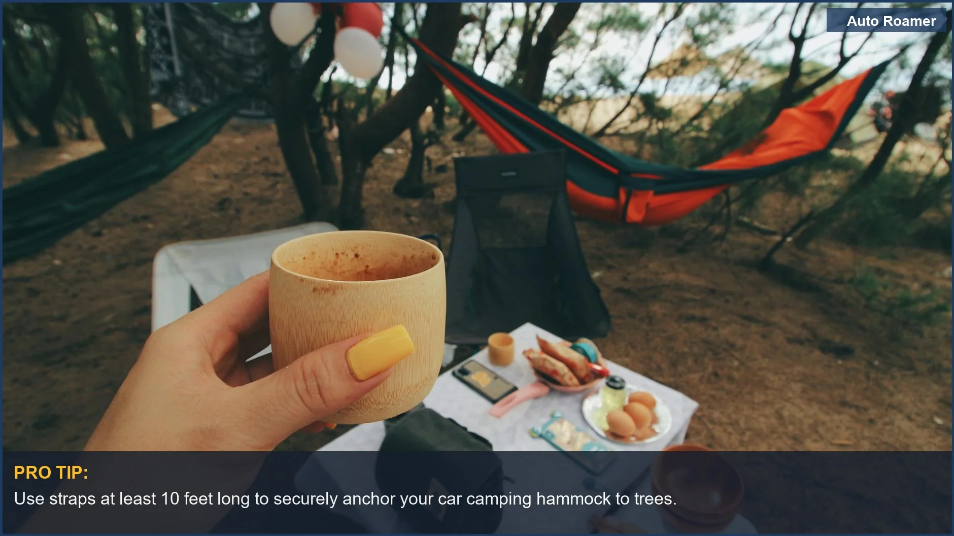 Cozy car camping setup with hammocks and a wooden cup under shady trees.