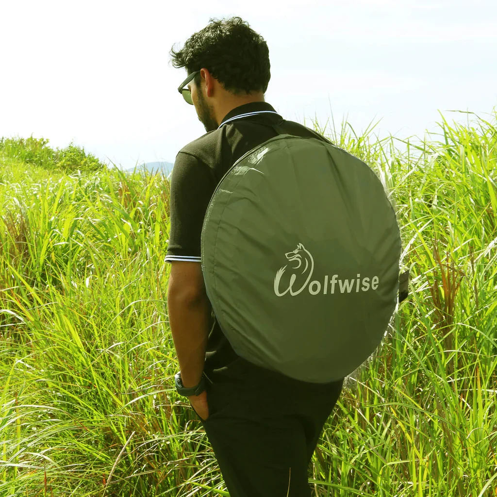 Packed pop-up privacy shower tent carried in its round camping bag