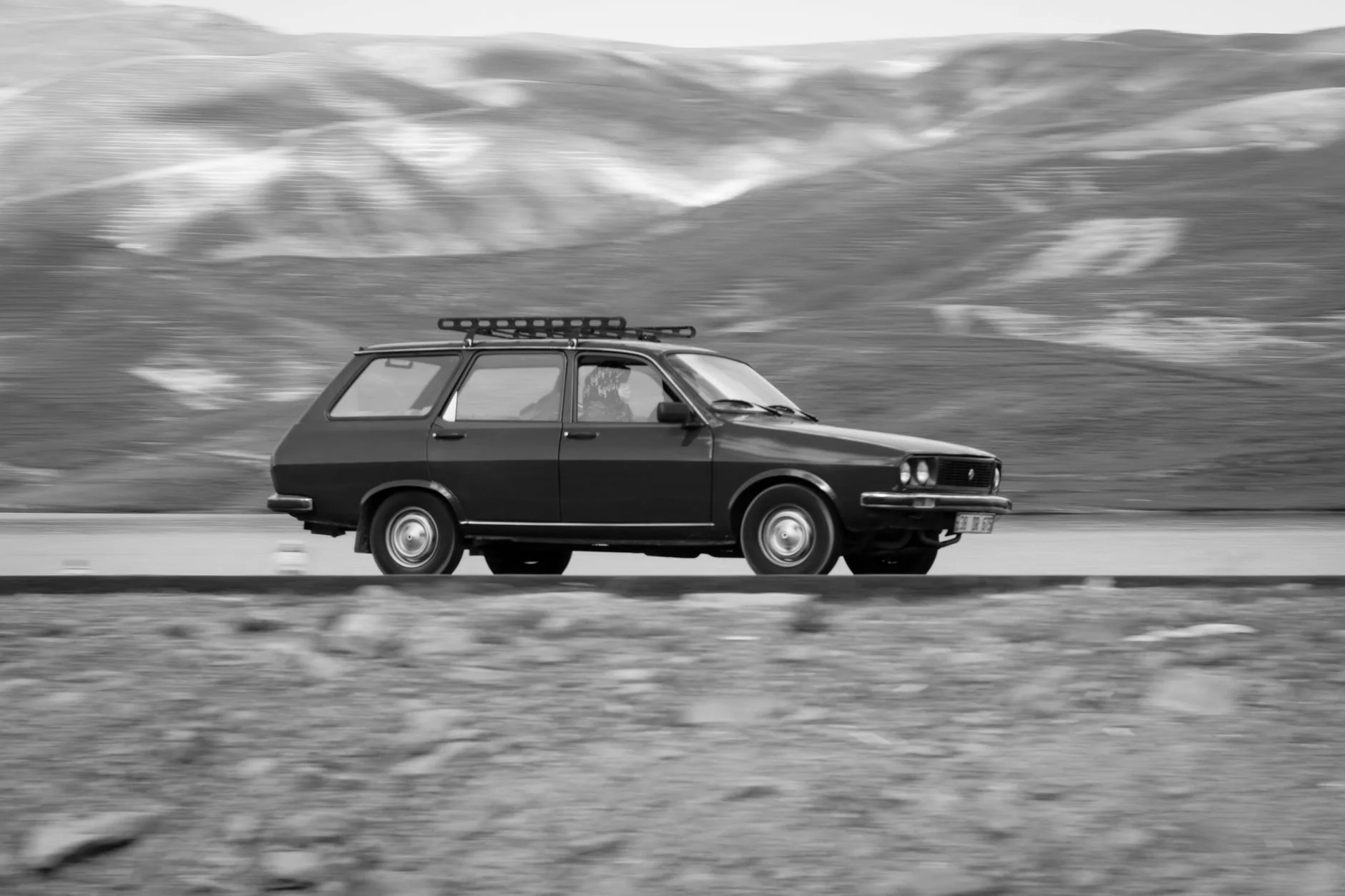 A Subaru-style wagon on a forest road, the kind of unpaved access its all-wheel drive and ground clearance are built for.