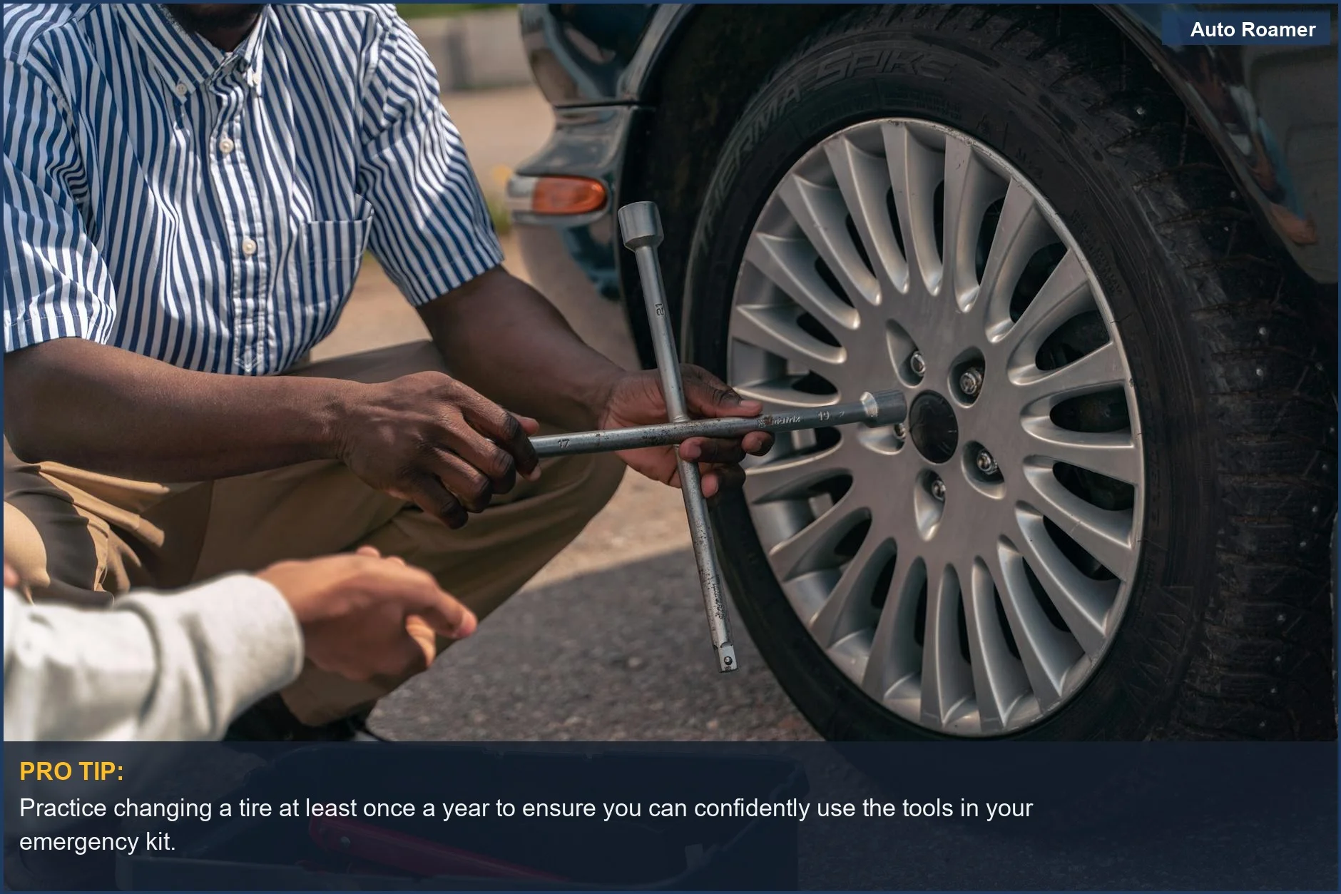 Adult teaches teenager how to change a car tire, emphasizing the importance of practical skills and a well-equipped car emergency kit.