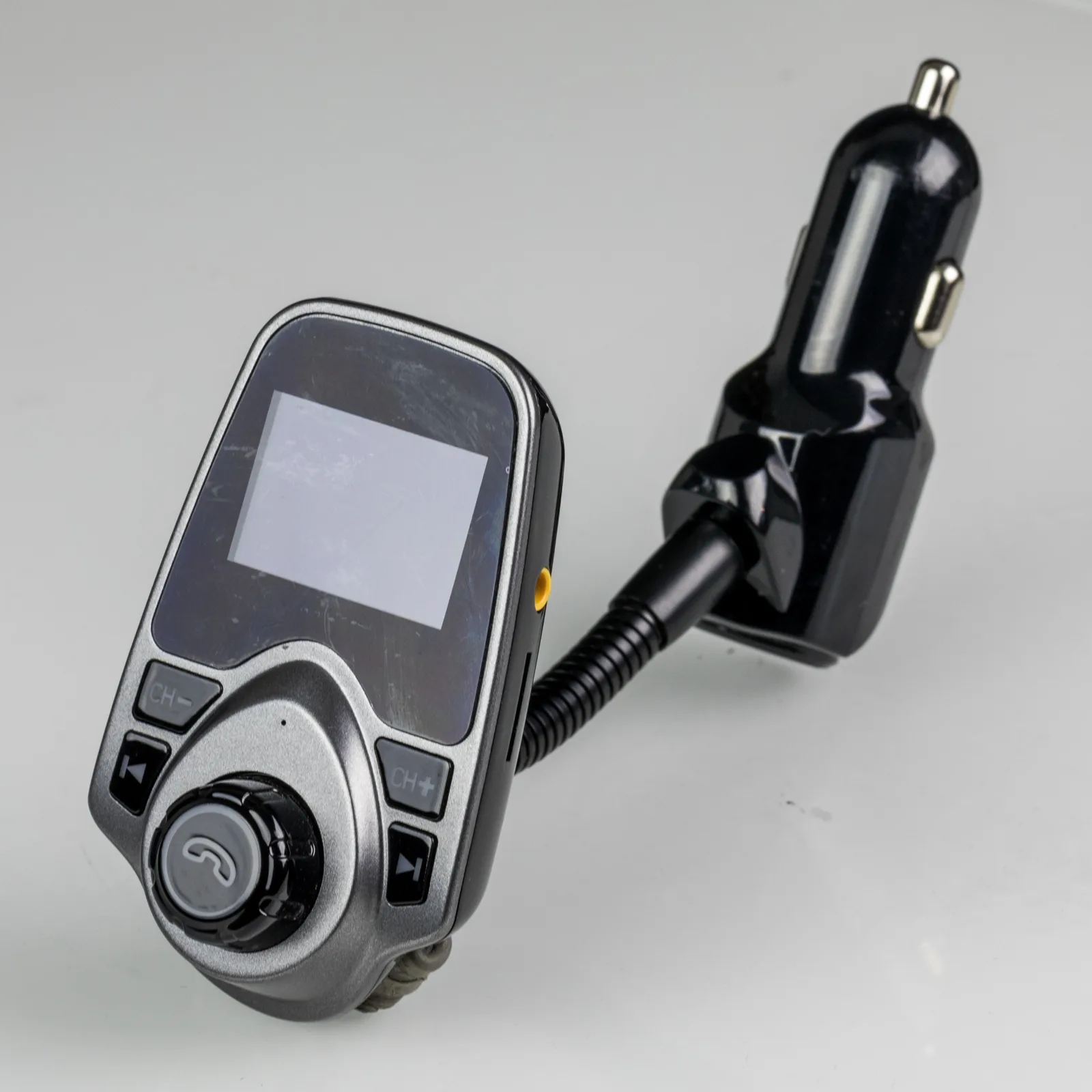 A T10 Bluetooth car FM transmitter with a small LCD screen, control buttons and a gooseneck 12V cigarette-lighter plug