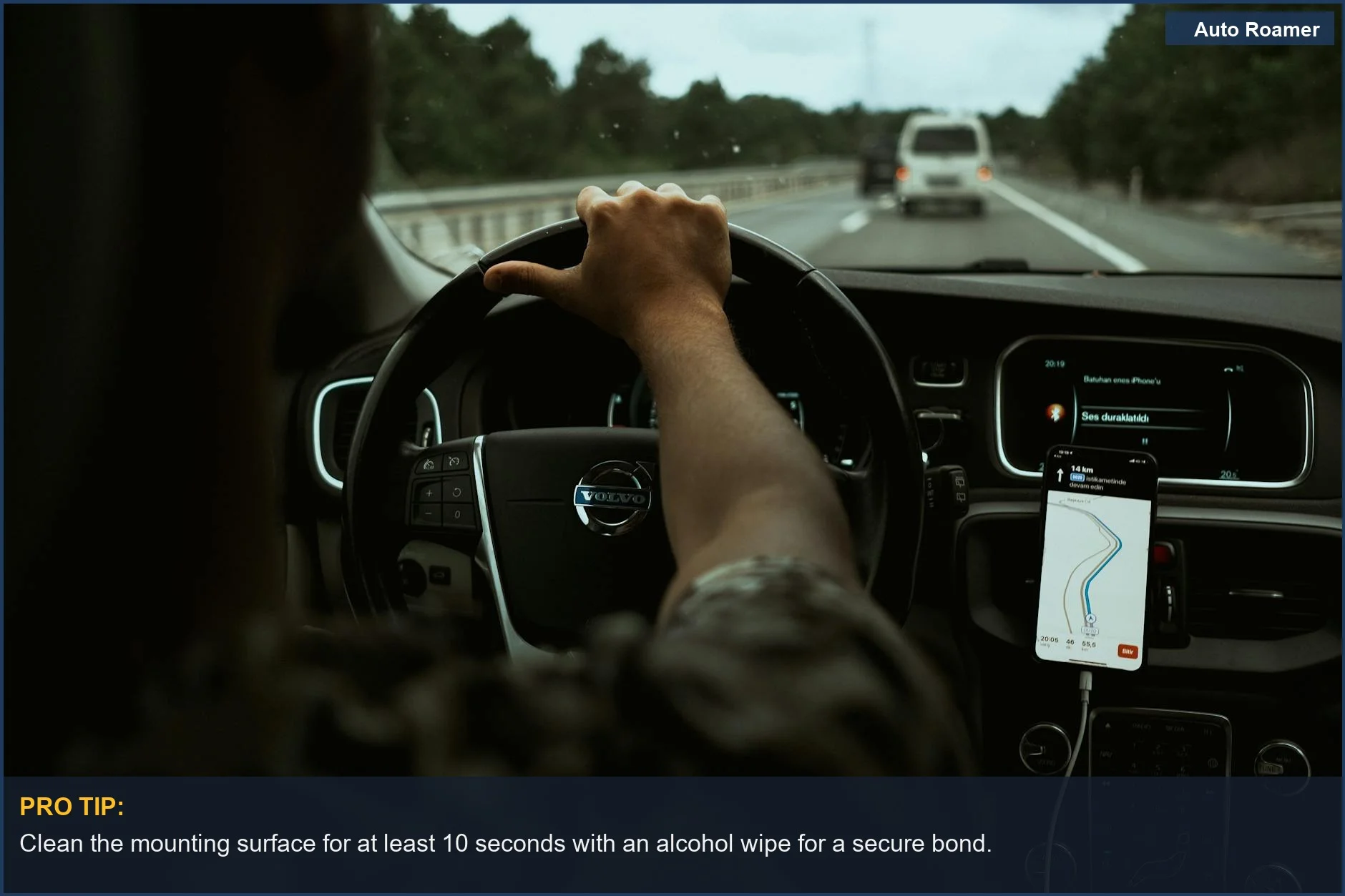 Driver relies on smartphone GPS for highway navigation in a modern car interior.