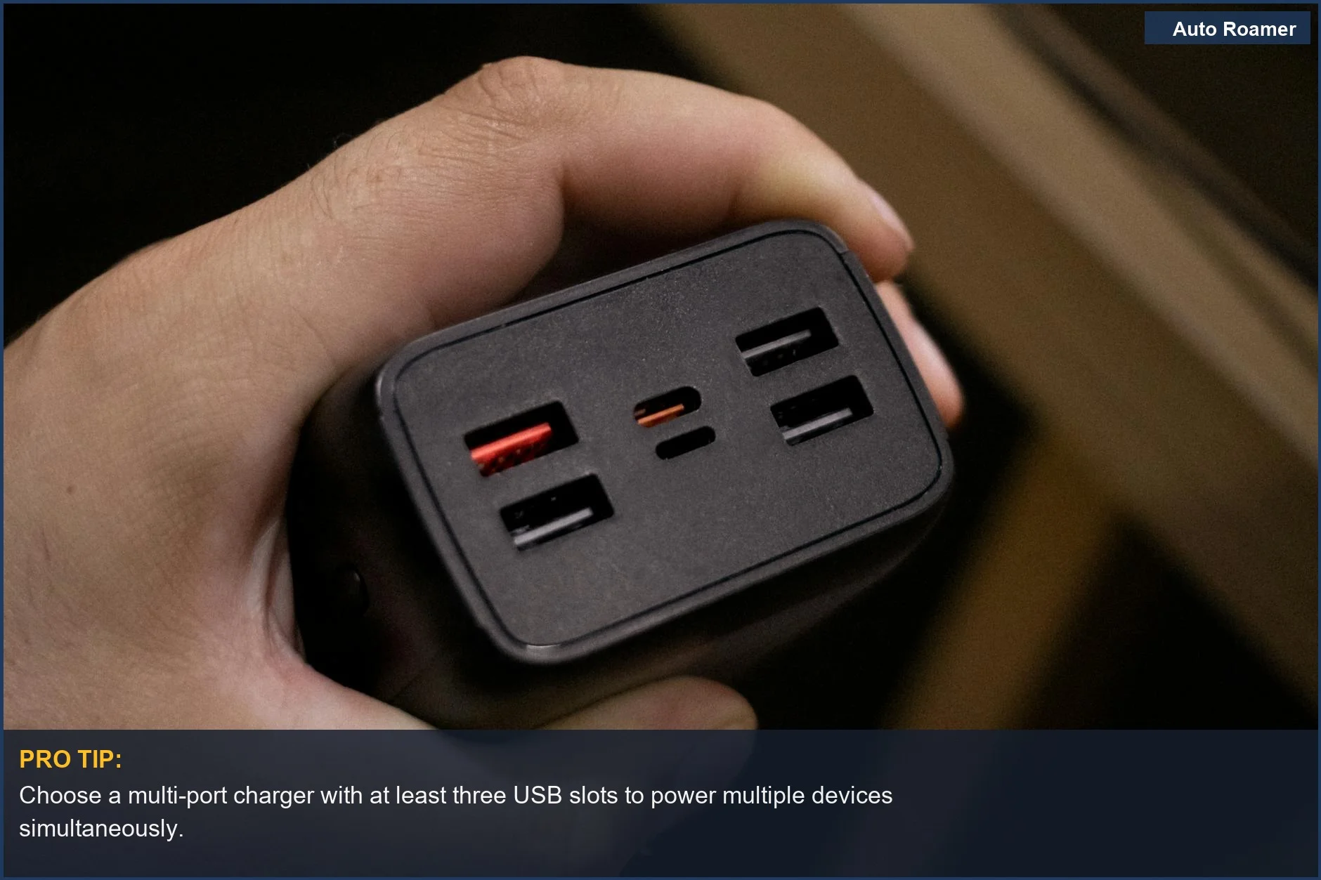 Close-up of hand holding a multi-USB port car charger adapter for road trip power solutions.