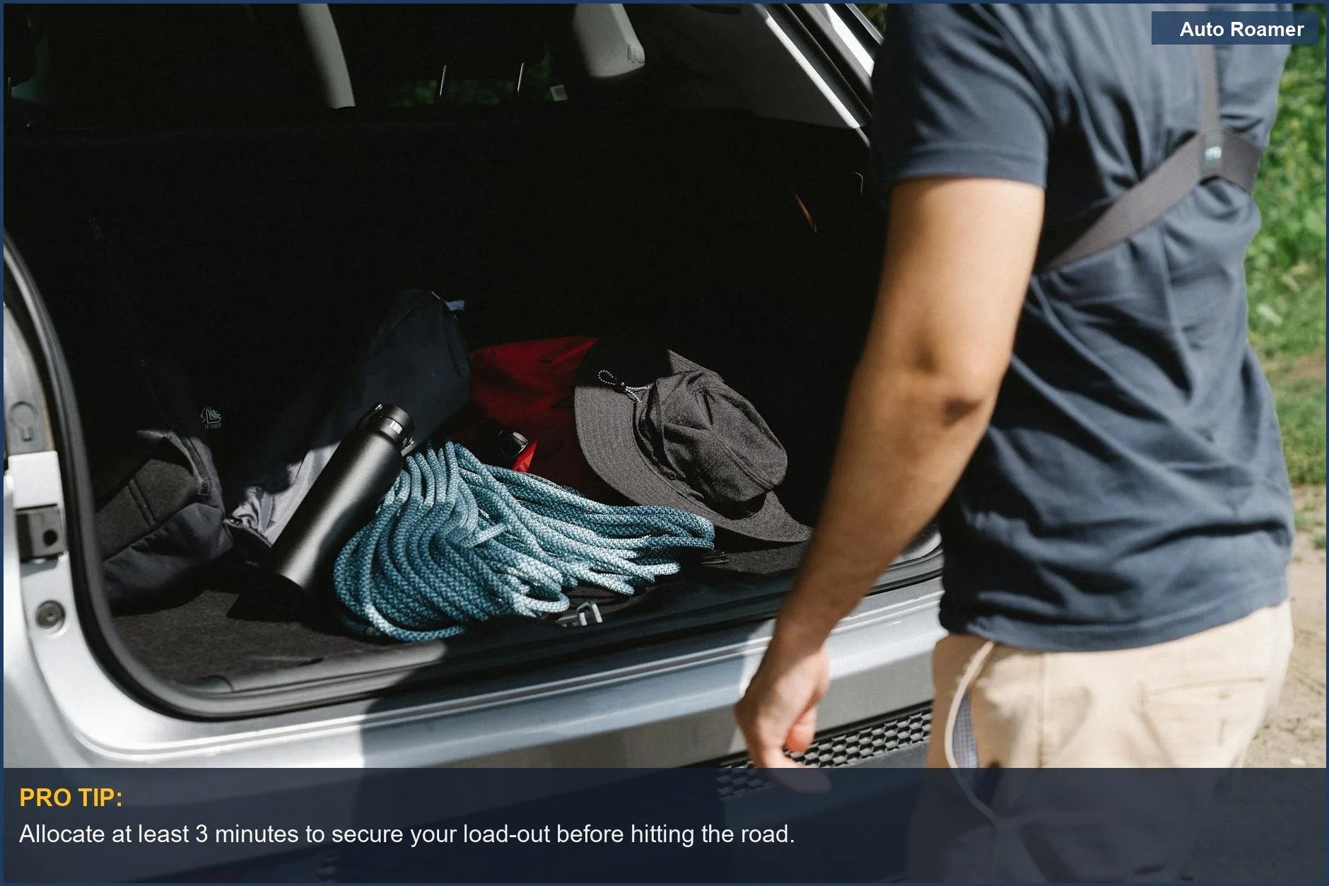 Man organizing camping gear in car trunk, essential for the best SUV camping cargo organizers.