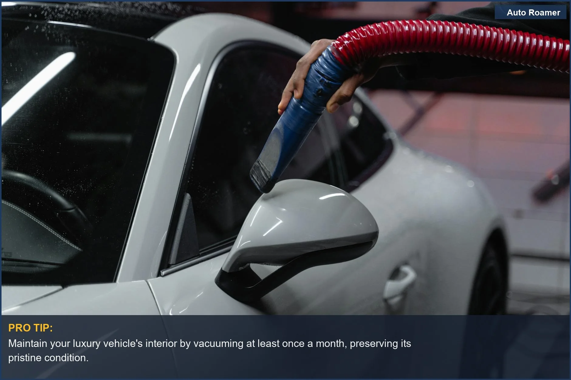 Meticulously vacuuming a white sports car interior indoors for a flawless, showroom-ready shine.