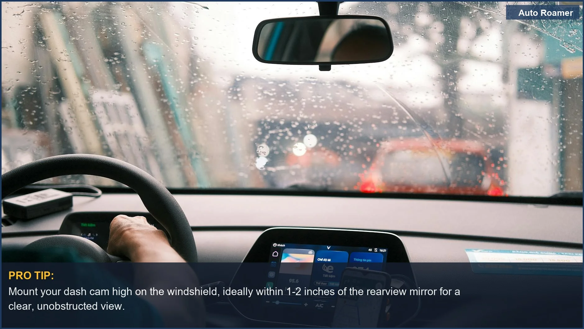 Interior car view during a rainy city drive, focusing on dashboard and windshield for optimal dash cam view.