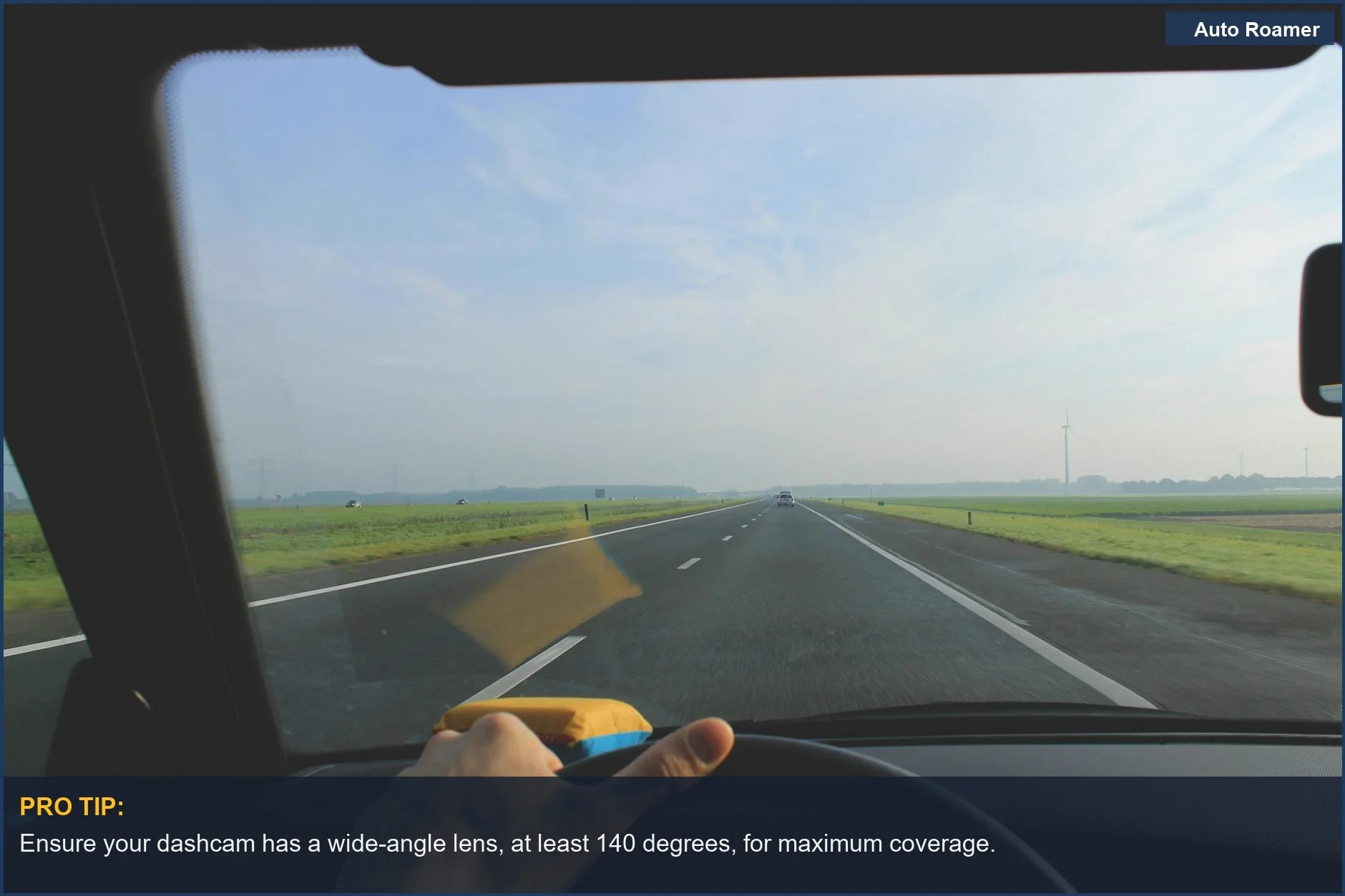 Driving view from a car's windshield down an open highway on a clear day.