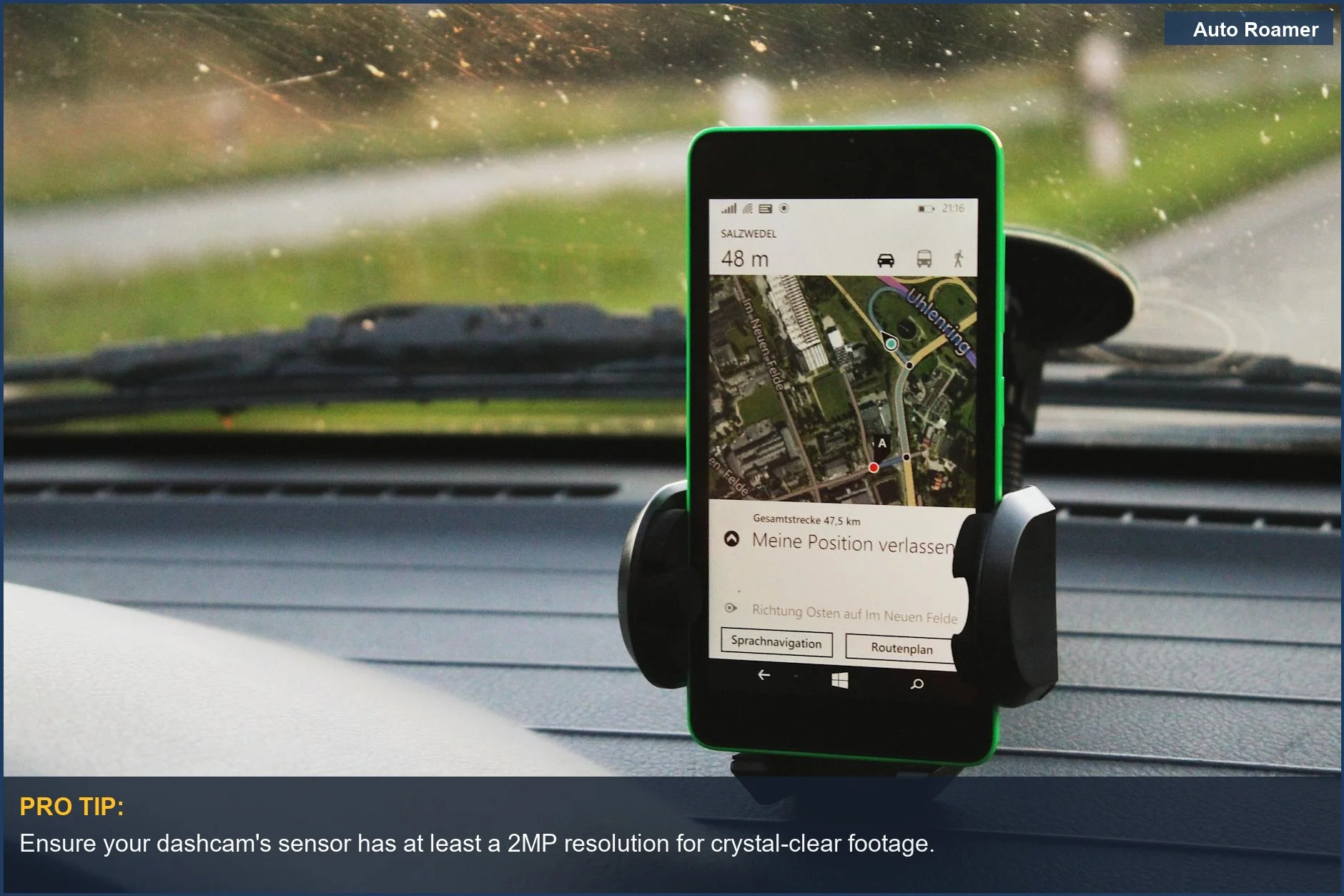 Modern dashcam with cloud storage and parking mode mounted on a car dashboard during daylight.