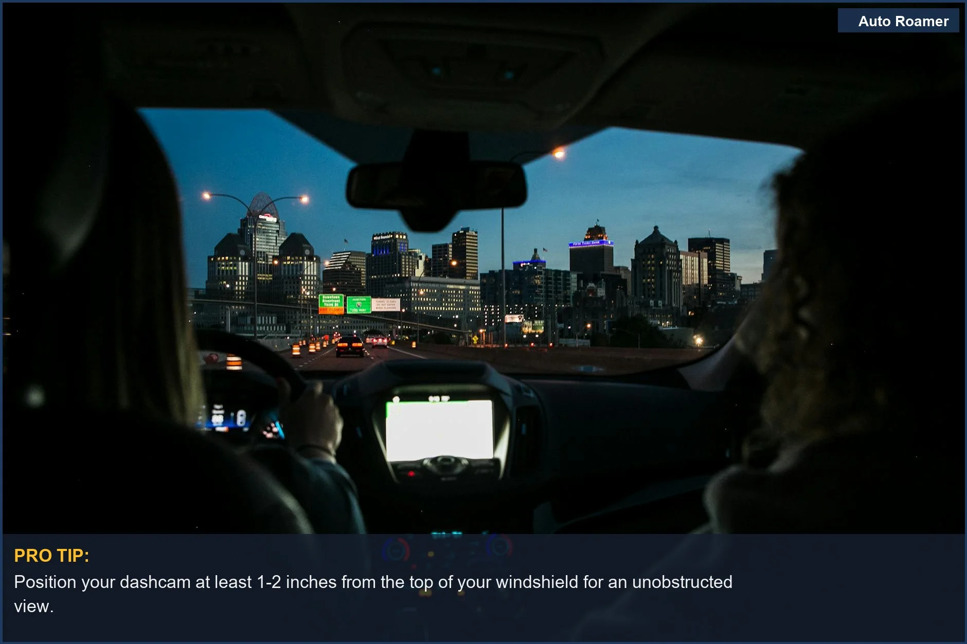 Night drive city skyline view through a car windshield, perfect for capturing road trip memories after dark.