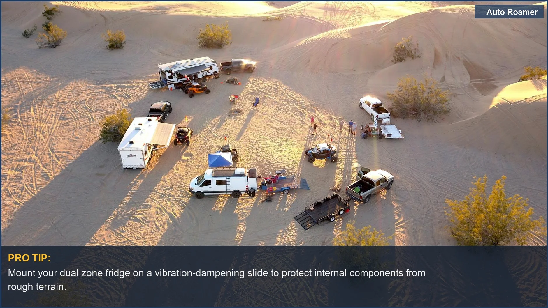 Drone view of a desert campsite at sunset with vehicles and trailers, ideal for testing dual zone portable fridges.