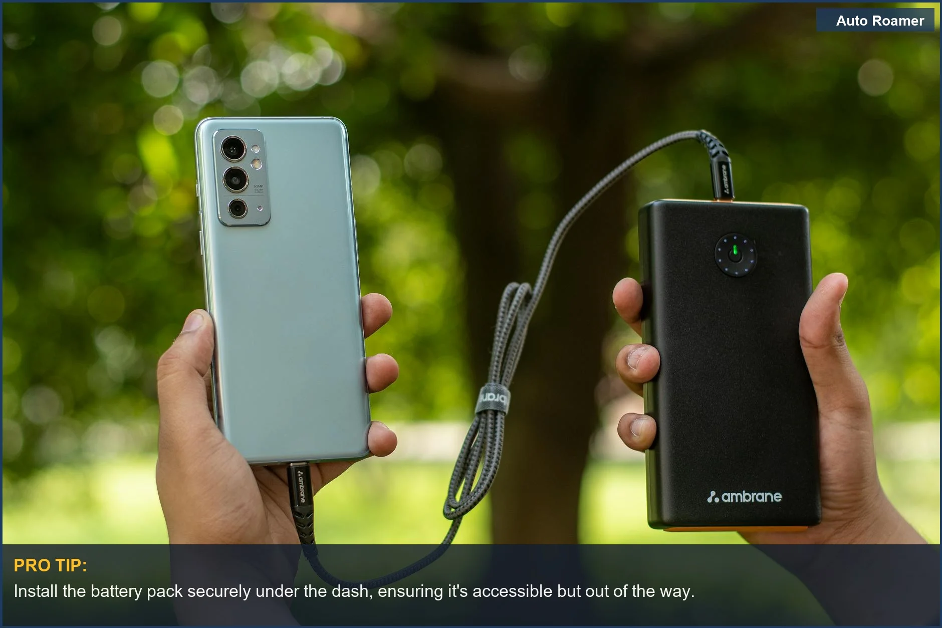 Hands holding smartphone connected to power bank outdoors, demonstrating portable charging solutions for devices.