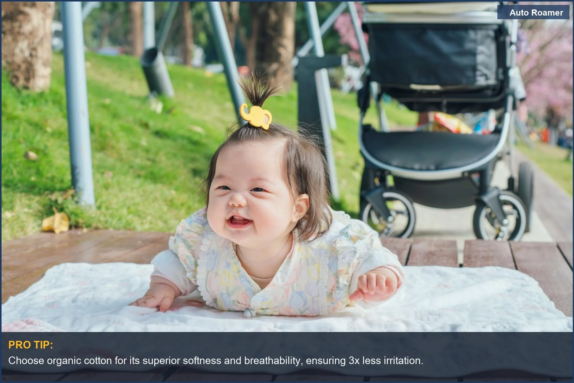 Smiling baby on a blanket outdoors, showcasing breathable baby clothes for travel comfort.