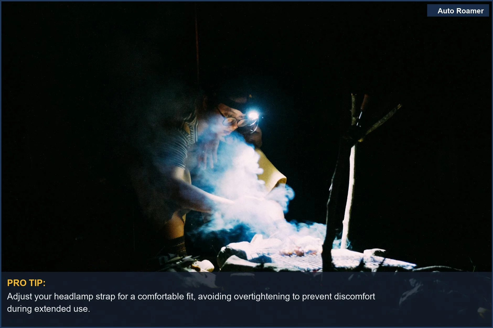 Person cooking at night over a campfire with a headlamp, emphasizing hands-free convenience for car camping tasks.