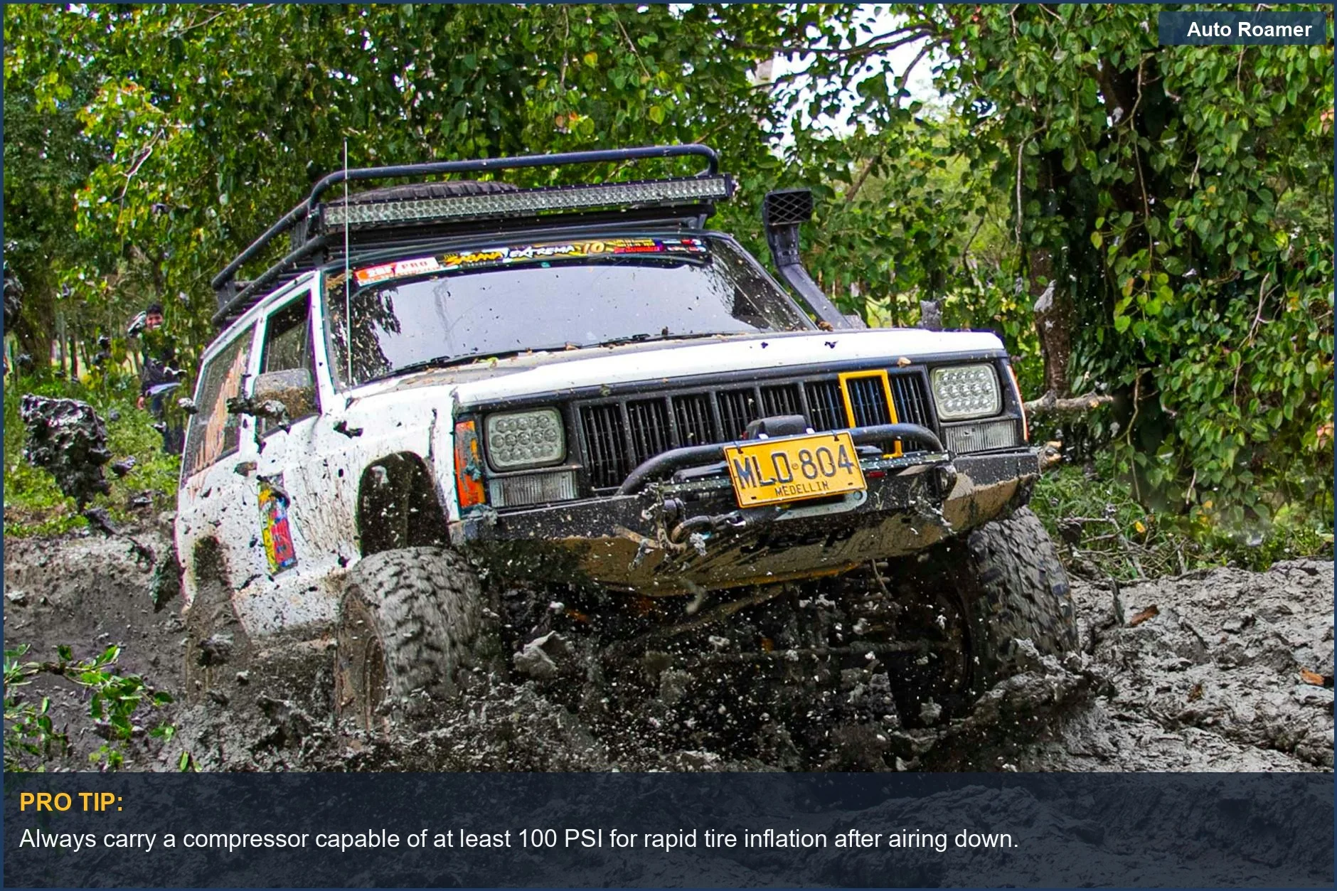 Jeep navigating challenging muddy terrain, emphasizing the importance of a powerful portable air compressor for off-road journeys.