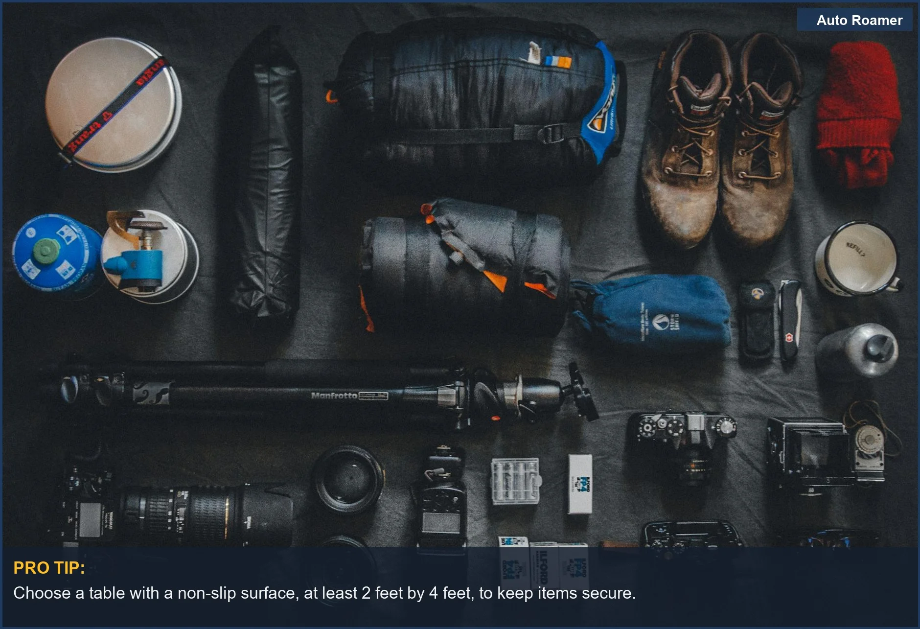 Neatly organized flat lay of photography and camping equipment, ideal for planning your car camping trip.