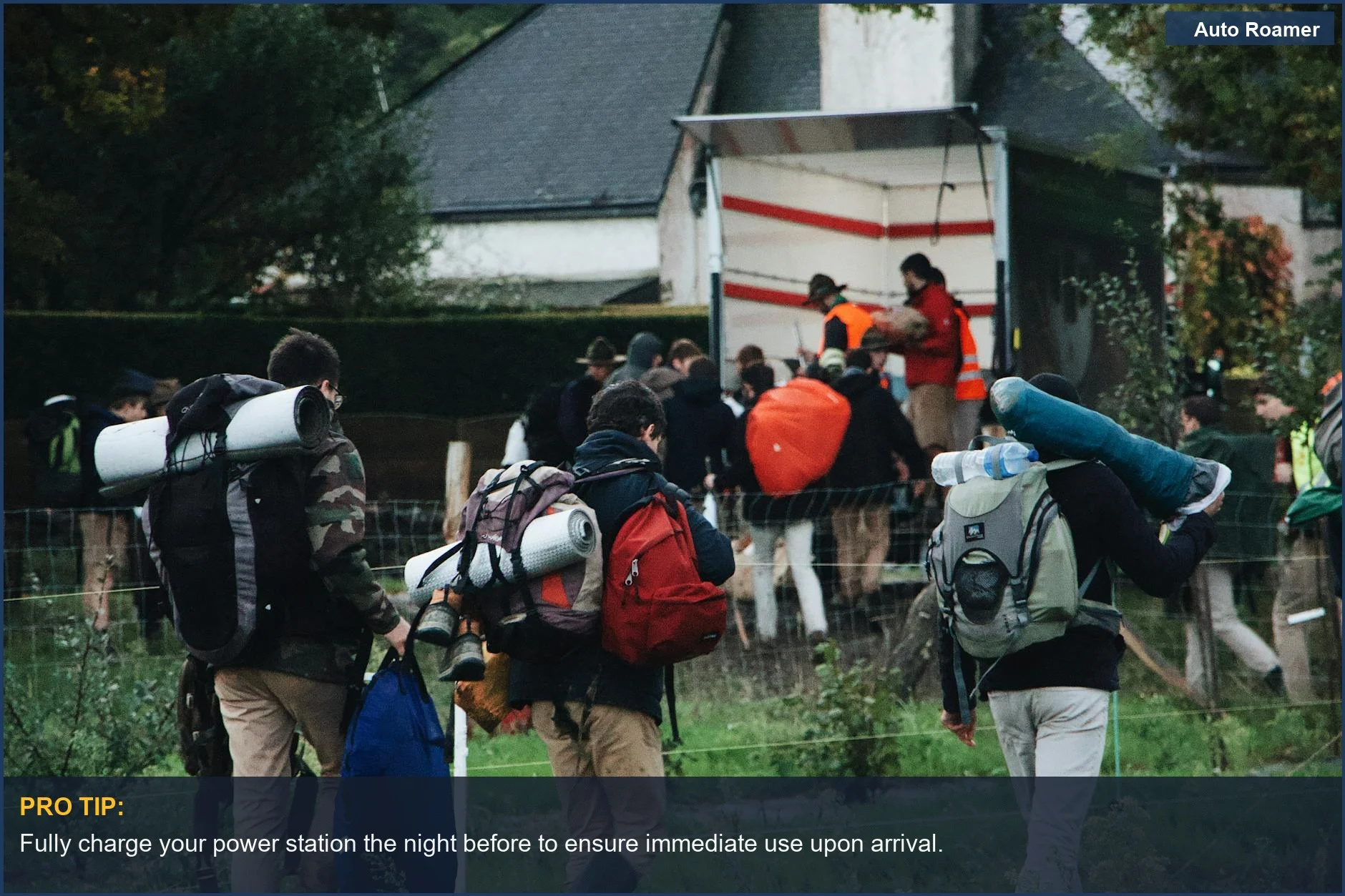Group carrying backpacks and camping gear towards a truck, showcasing readiness for power station use.