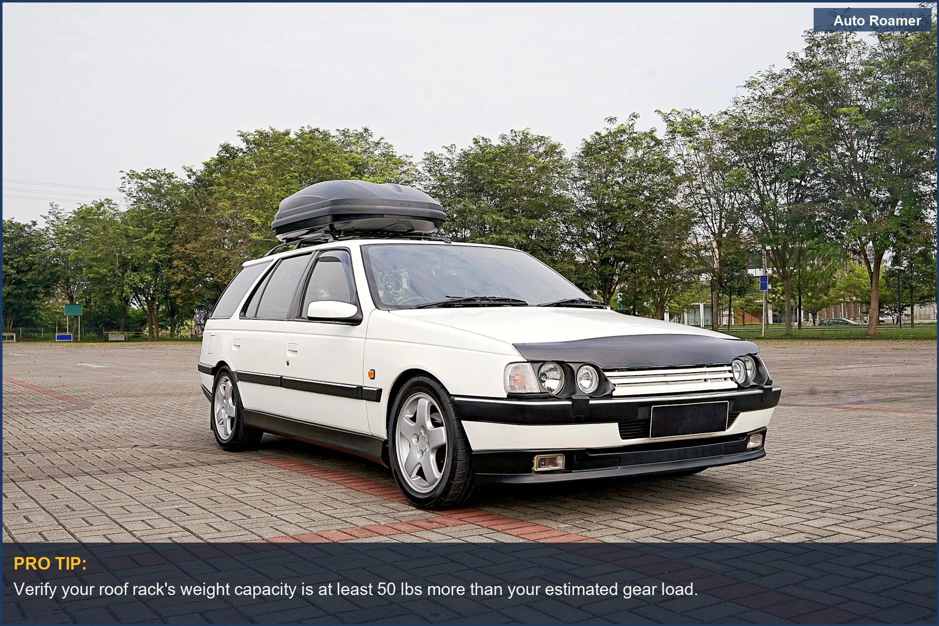 Classic white station wagon with a large rooftop cargo box, ideal for car camping gear storage.