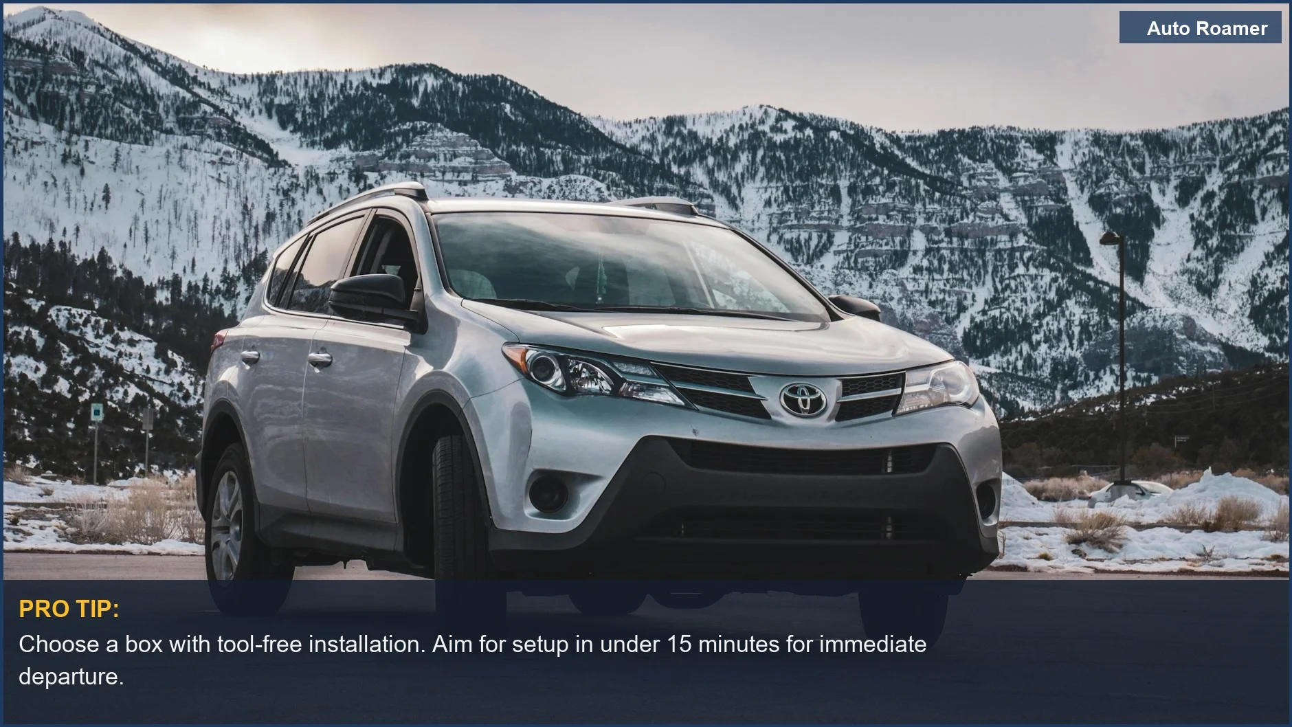 Silver SUV parked before snowy mountains, showcasing the need for quick rooftop cargo box installation.
