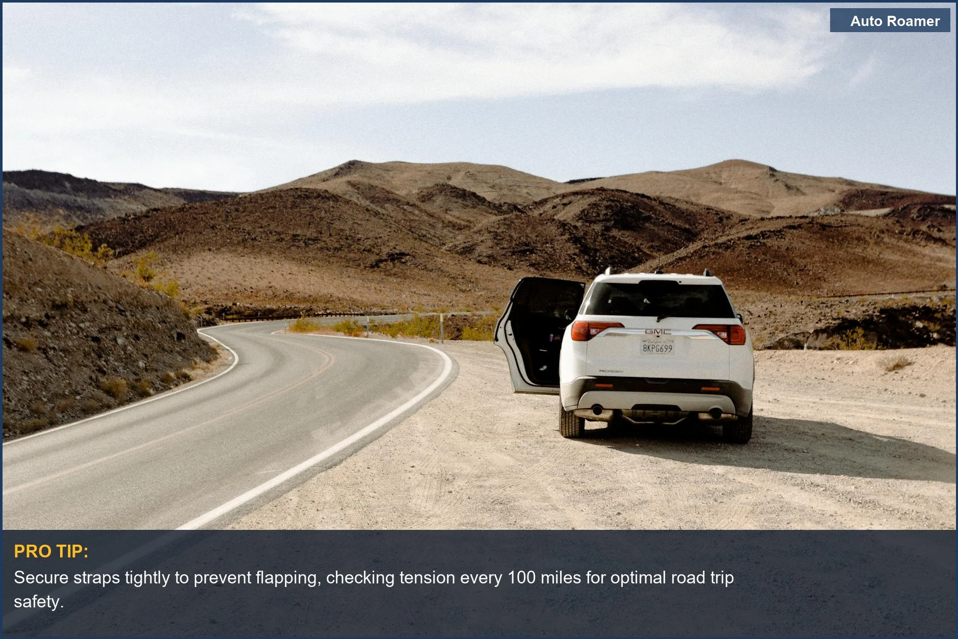 White SUV on a winding desert road, perfect for showcasing the best soft roof cargo bag for road trips.