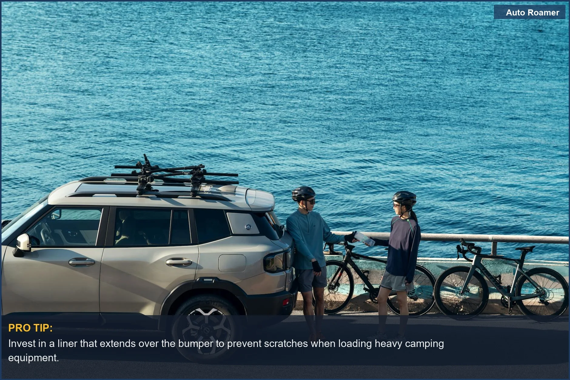 Cyclists with gear-laden SUV parked by the blue ocean, showcasing travel readiness with a cargo liner.