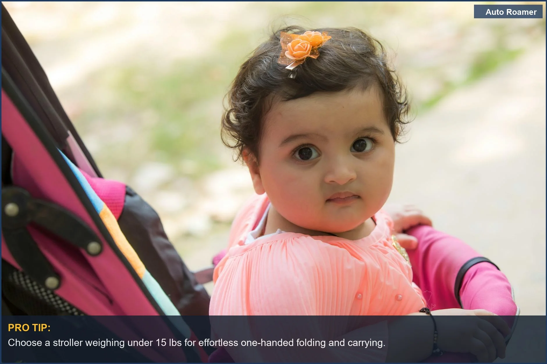Curious baby girl with curly hair in a lightweight travel stroller on a sunny day, exploring the outdoors with ease.